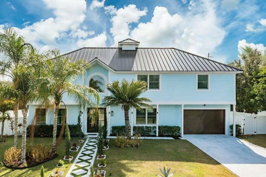 Spectacular, 2 story home is a  masterpiece of design & functionality,  situated on a prime corner lot. The home boasts 5 bedrooms and 4 bathrooms, 10-ft ceilings w/ new Anderson impact windows/doors. Chef's dream, Viking appliances. Porcelain tiles throughout.The grand primary suite is a private retreat, tremendous walk-in, spa-like en suite bathroom provides a luxurious escape. The backyard features a new, heated in-ground pool, captivating infinity-edge jacuzzi,  and cabana bath. Generator hookup, a tankless water heater, and propane hookups for both the gas range and an outdoor grill. .Minutes to gourmet restaurants , golf and beaches.