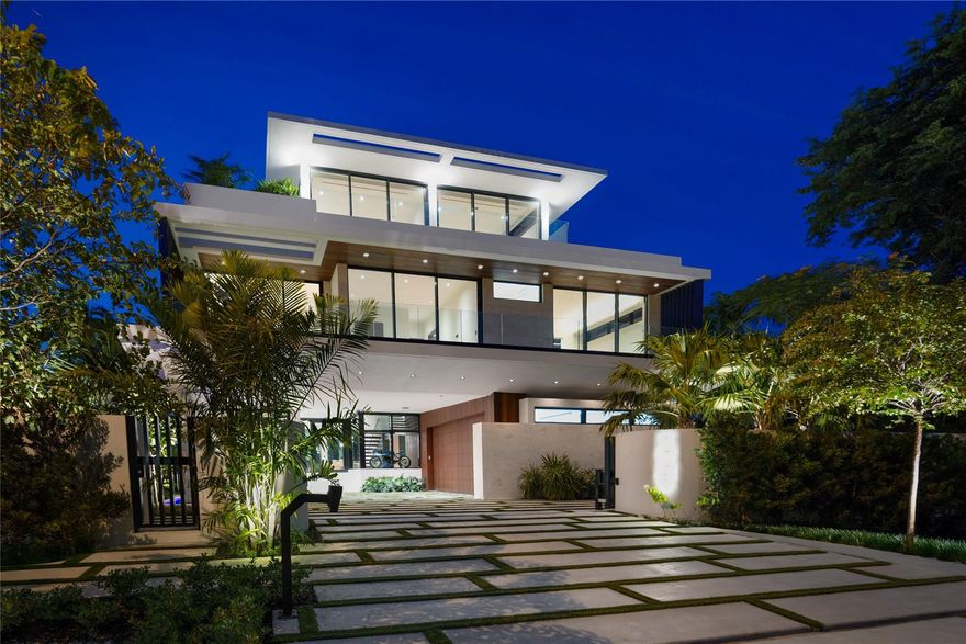 Welcome to Eleven Rio: a tropical modern 3-story poured in place concrete custom residence setting a new bar in East Lauderdale. Enter a dramatic cantilevered entry with covered parking. Lush landscape, upper level planters, waterfalls in front & back for serene elements. Architectural IPE-clad garage doors prewired for lifts. Lutron automated, top-tier finishes throughout. Primary suite with built-in sauna and curbed glass shower, plus VIP suite. Natural stones, oak stairs with leather railing. Italkraft closets, cabinets, doors and kitchen with Wolf/Sub-Zero, hidden pantry, butlers pantry & 314-bottle wine room. 3rd floor sunset lounge and summer kitchen with views of downtown and water. Infinity-edge pool, spa. Full-house generator. Minutes to the ocean, steps to Lauderdale Yacht Club.