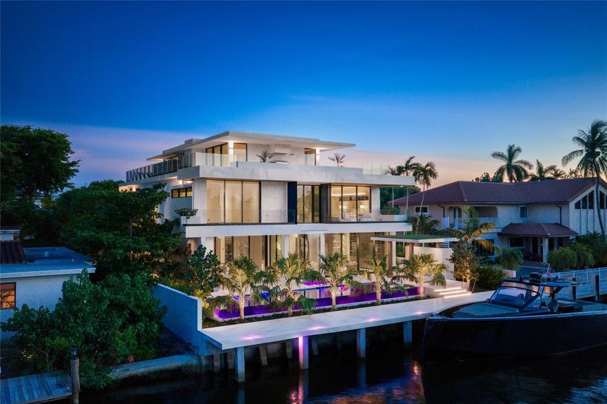 Welcome to Eleven Rio: a tropical modern 3-story poured in place concrete custom residence setting a new bar in East Lauderdale. Enter a dramatic cantilevered entry with covered parking. Lush landscape, upper level planters, waterfalls in front & back for serene elements. Architectural IPE-clad garage doors prewired for lifts. Lutron automated, top-tier finishes throughout. Primary suite with built-in sauna and curbed glass shower, plus VIP suite. Natural stones, oak stairs with leather railing. Italkraft closets, cabinets, doors and kitchen with Wolf/Sub-Zero, hidden pantry, butlers pantry & 314-bottle wine room. 3rd floor sunset lounge and summer kitchen with views of downtown and water. Infinity-edge pool, spa. Full-house generator. Minutes to the ocean, steps to Lauderdale Yacht Club.