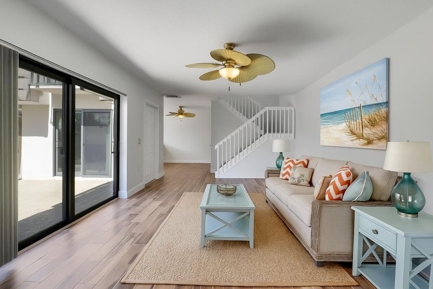 Discover your dream coastal retreat just minutes from Marcinski Beach and the Pier. This beautifully updated home features two spacious primary bedrooms and two and a half bathrooms. The newly renovated kitchen boasts stunning blue lower cabinets, elegant gray uppers, and quartz countertops, complemented by a state-of-the-art stainless steel appliance package with an oven air fryer. Enjoy the exquisite Brazilian pecan porcelain tile floors throughout, with cozy Berber carpet on the stairs. Modern conveniences include hurricane impact glass sliders, a hurricane-resistant front door, and a new washer/dryer. The private fenced patio with SunDek flooring offers a serene space, perfect for relaxation, complete with a shed for extra storage. The knockdown ceiling, lighting and paint scheme