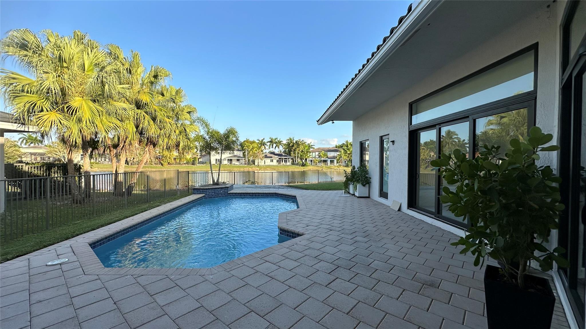 WESTON HILLS : Experience luxury 5 bedroom, 3 1/2-bathroom modern masterpiece. Nestled in the sought- after Weston Hills Club. New floors that flow throughout the house. Every bathroom has been remodeled, offering a spa-like experience. A new 2024 roof ensures worry-free living, while new 2024 impact windows and doors provide peace of mind and energy efficiency. Freshly interior and exterior paint and custom built-ins.
Gourmet kitchen, which features high-end designer appliances, huge center island, contemporary custom cabinetry, pantry, and a custom built in wine cooler. Enjoy views of the lake from landscaped backyard, newly resurfaced heated pool. All new closets . Additional updates include new washer and dryer and a spacious double garage with electric car charging station