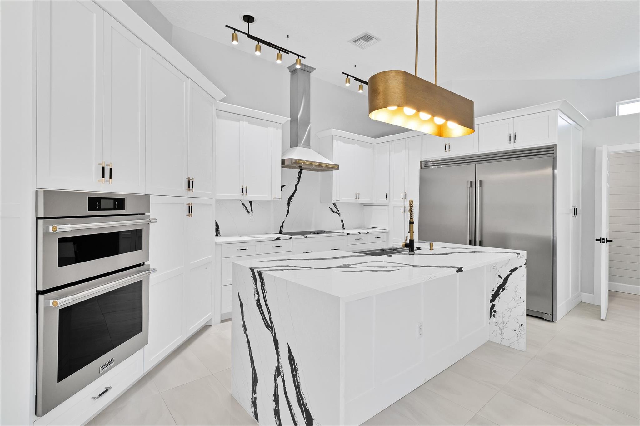 Breathtaking upgrades to this pool home + CASITA! Kitchen is a jaw dropper with STUNNING waterfall Quartz countertops, custom wood cabinetry, 66' fridge, 36' cooktop & vented hood. Primary bathroom is the epitome of luxury with quartz countertops, soaker tub, floor to ceiling tiled multi-jet shower & custom walk in closet. No surface has remained untouched-even the laundry room is worthy of a look. Home was designed for entertaining with built in bbq & vented hood poolside, custom drybar indoors & relaxing lakeside screened back porch. 2022/23-repiped, ACs, new lighting,paint, molding/casing, 15x30 porcelain tile throughout & so much more. LESS than 1 mile to beach: Neighborhood offers clay tennis, community pool &workout facility. Adjacent to the Historic Jungle Trail for riverside walks