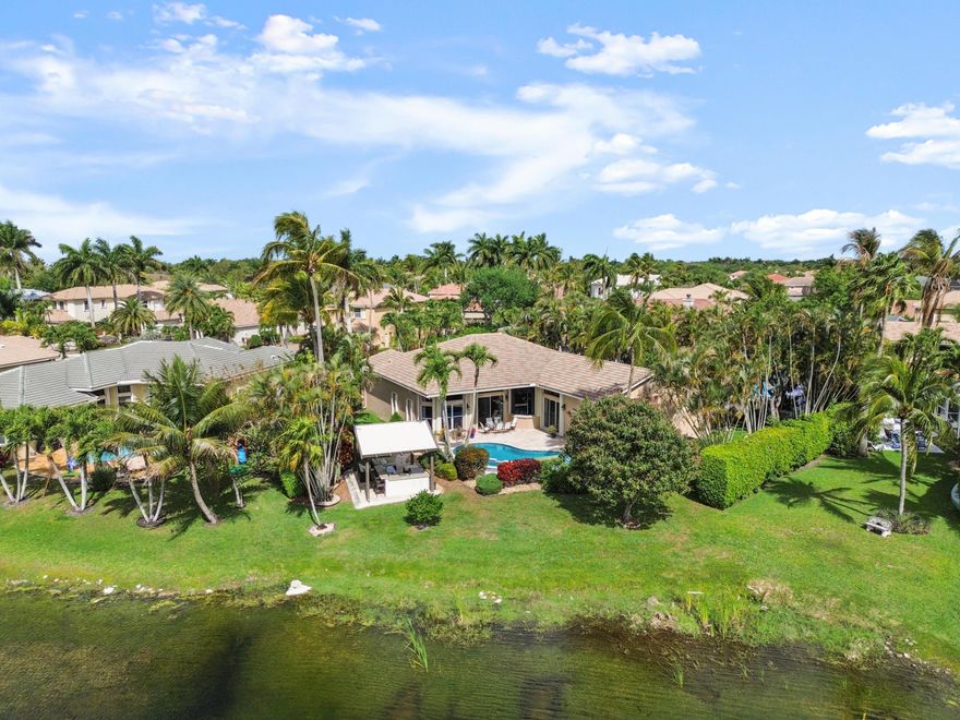 Rare opportunity to own this oversized lot beautifully maintained 5-bedroom, 3.5 bath lakefront home gated community of Wyndham Lakes  Grand Isles. Triple split with spacious open layout, freshly painted, features soaring ceilings, abundant natural light. Step outside to your private fenced backyard oasis with breathtaking lake views, a resurfaced heated pool and spa, Travertine patio, and a stunning gazebo complete with built-in BBQ, sink, bar seating, and lounge area. Inside, enjoy an updated primary bathroom, spacious living areas, and an upgraded 3-car garage with ample storage. Original owner, move-in ready home sits on a lushly landscaped oversized lot. Low HOA includes guard-gated entry. Conveniently located near top-rated schools, Publix, Costco, shopping, dining, and more.