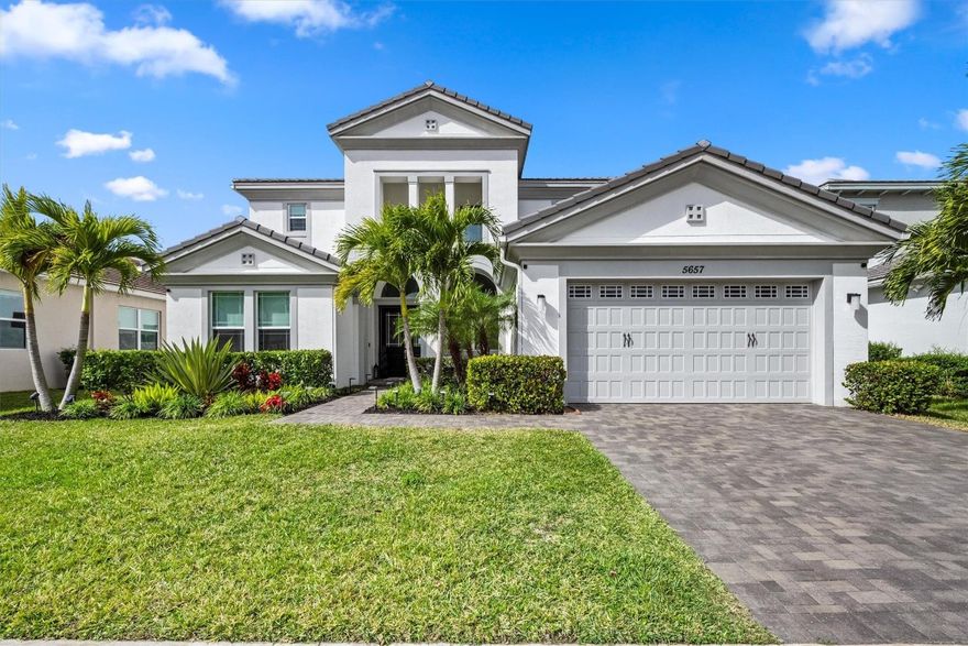 Step into this beautifully upgraded two-story home in Westlake, featuring a grand spiral staircase, elegant porcelain tile flooring, a designer foyer light, impact windows throughout, and a 3-car garage with built-in cabinets. The owner’s suite showcases a structural balcony upgrade, custom closets, and serene lake views. A dedicated office with built-ins, a custom closet in the second bedroom, wood-look flooring from the staircase through the second floor, and a turf backyard ideal for play. Enjoy a complete home water filtration system, tankless water heater, and fenced yard. Seller offering $10,000 toward closing costs. Westlake offers resort-style amenities, a pool, splashpad, snack shack, dog park, basketball courts, and expanding businesses within this vibrant, growing community. Ideal for buyers relocating to West Palm Beach or out-of-state buyers relocating to Florida. Move-in ready home in a resort-style, master-planned community in Westlake, Palm Beach County. Low HOA, impact windows, lake views, family-friendly neighborhood, and easy access to major highways, shopping, dining, and Palm Beach International Airport. Westlake FL homes for sale, Palm Beach County real estate, resort-style community, new construction-style home, impact windows, lake view, 3-car garage, fenced yard, low HOA, move-in ready, family-friendly neighborhood.