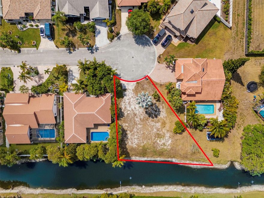10,025 Sq Ft Vacant Lot with Canal Frontage – Coral SpringsBuild your dream home on this spacious lot located on a quiet cul-de-sac in one of Coral Springs' most desirable areas. Enjoy peaceful canal views and added privacy. The lot is cleared, flat, and ready for development. Zoned for residential use. Close to top-rated schools, parks, shopping, dining, and major highways. Rare opportunity to own waterfront land in a well-established neighborhood.