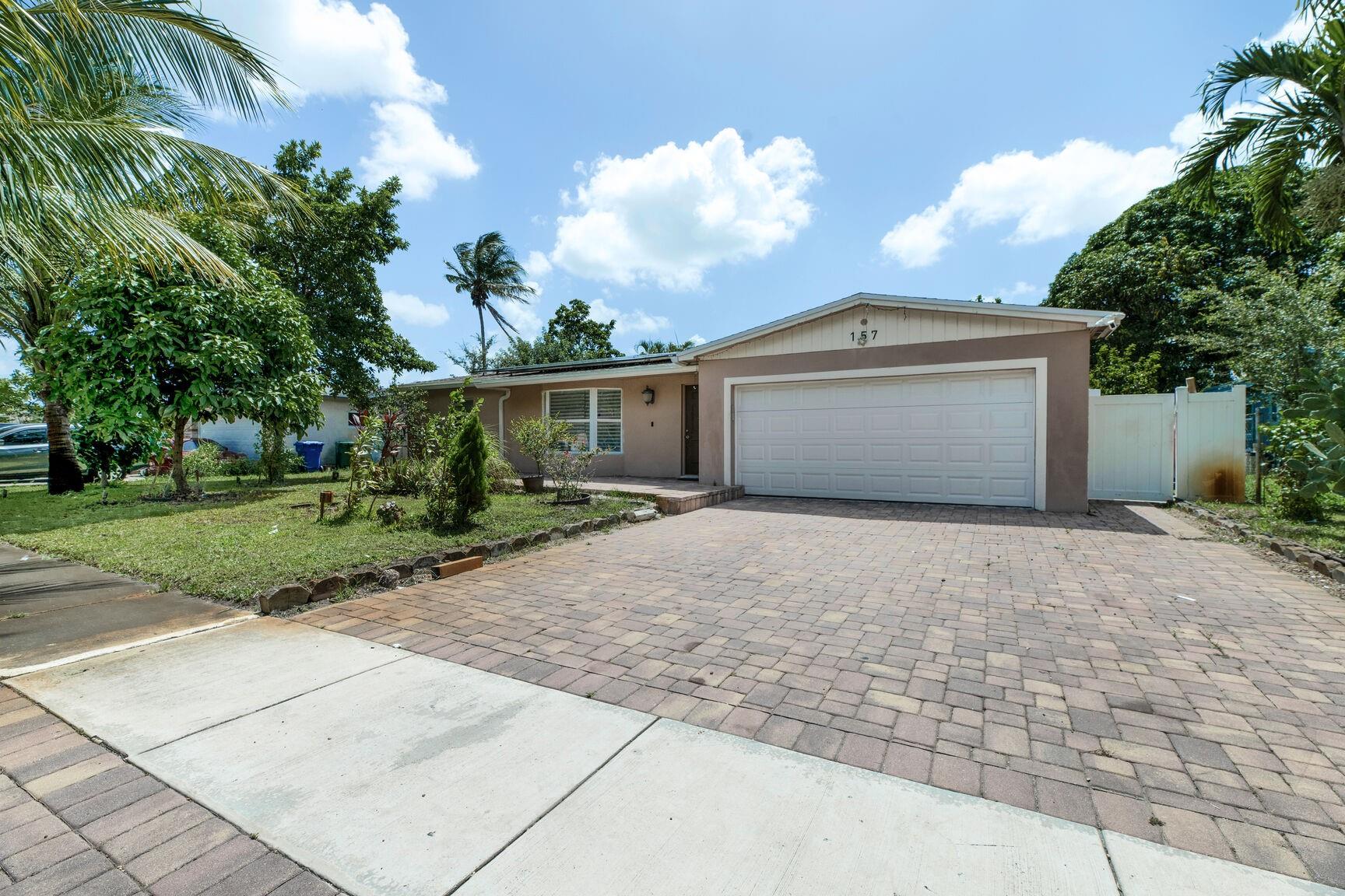 NO HOA! Welcome to this stunningly renovated 4 bedroom, 3 bathroom home! Brand-new kitchen complete with vent hood, stove top, quartz countertops, stainless steel appliances. Home features new tile flooring creating a fresh, modern feel. Outside, you'll find a private oasis with a screened pool recently diamond brite, pavers on pool deck, and a fully fenced yard, perfect for relaxing or entertaining. The bathrooms fully updated with new vanities and quartz countertops, glass shower doors. Home features solar panels, hurricane rated 2025 garage door with epoxy garage floors , tankless water heater, landscape lighting. House is wired for speaker. Property is fruited with avocado, coconuts, ackee, apple and mango. Move in ready!
