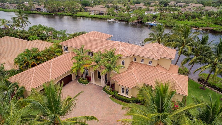 Newly updated riverfront estate in private gated enclave with 230' of water frontage and fabulous panoramic views! This spacious 2 story home feels brand new with recent designer refurbishing, all new gourmet kitchen, all impact glass, Jerusalem stone floors, fireplace in living room and first floor master suite with separate office. Covered loggia has summer kitchen, 45KW generator, gorgeous open pool/spa, newer dock with boat & jet ski lifts and minutes to Jupiter Inlet!