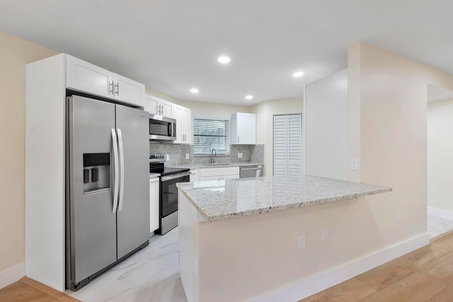 Better Than New! Just steps to the Pool. This lovely 2/2 ground-floor unit has been completely renovate and re-imagined, ensuring total peace of mind for years to come. Taken down to the concrete and rebuilt with quality materials.The layout was opened up to create a light-filled living space perfect for entertaining. The kitchen is featuring top notch appliances and a custom-integrated laundry closet designed for maximum aesthetic appeal. Every inch of this home from the plumbing and electrical to the A/C and water heater is brand new. With new lighting throughout, new window treatments, and a freshly screened patio, there is absolutely nothing left to do but move in. Rarely does a unit with this level of "to-the-studs" craftsmanship hit the market. Bring your most discerning buyers.