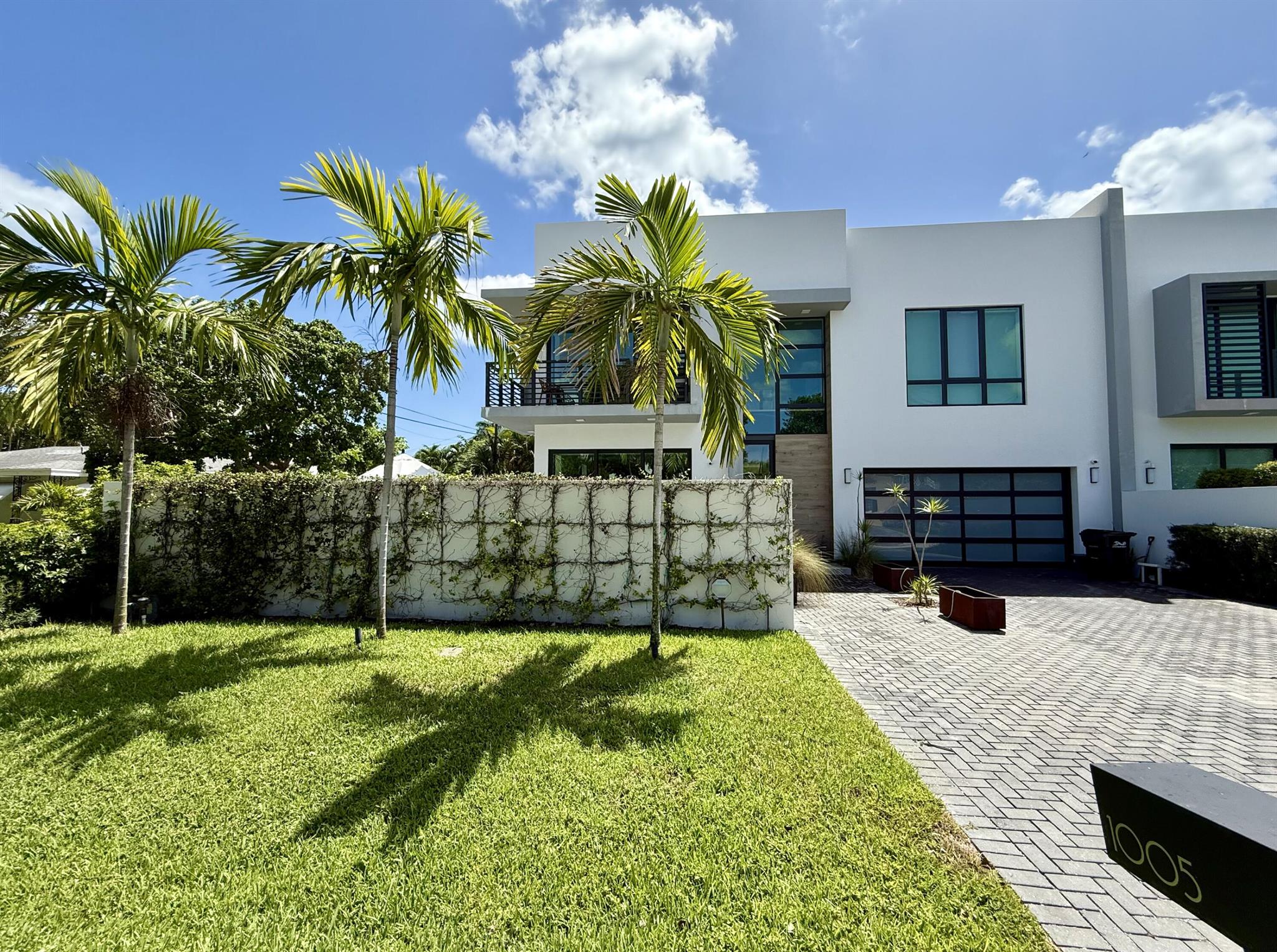 Designed by Richard Jones and built by Southshore Builders, this 3,133+/- TSF townhouse blends sleek modern design with refined finishes. High ceilings, urban tile, and white oak floors set a sophisticated tone throughout. Just a half mile to the beach and 1.5 miles from Delray's Atlantic Avenue, the location is ideal for a true coastal lifestyle.A dramatic two-story entry opens to a light-filled great room and a chef's kitchen with a large island, waterfall counters, custom cabinetry, and top-tier appliances. Pocket sliders extend the living space to a private patio and a second outdoor retreat with a heated resistance pool, all surrounded by lush landscaping that ensures total privacy.