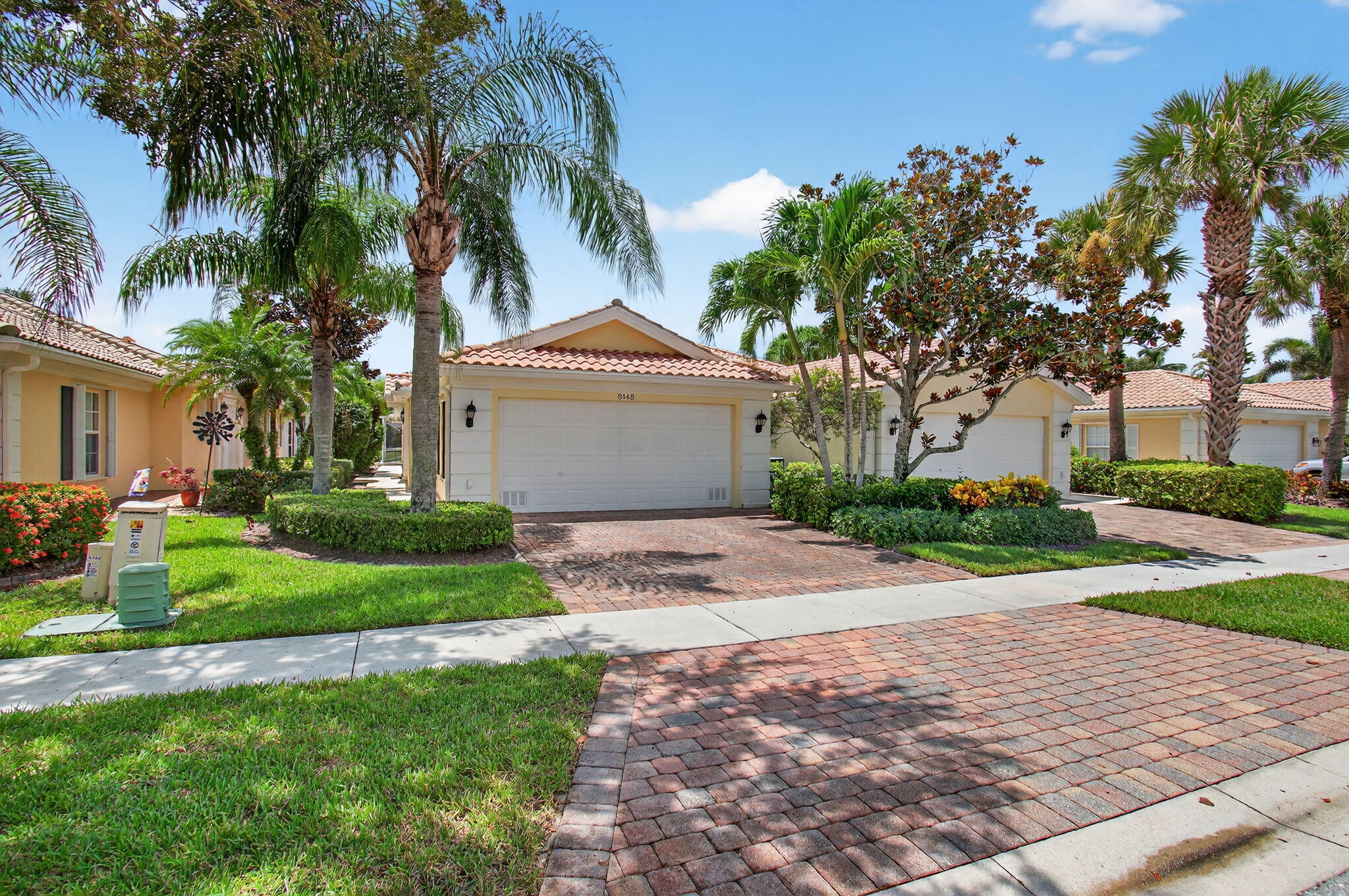 Step into this sought-after Capri model in VillageWalk of Wellington. With over 1,500 sq ft of living space, this 2 bedroom, 2 bath home offers an open floor plan that's light and inviting. The living and dining areas flow seamlessly, with sliding glass doors that showcase tranquil lake views and open to your private screened-in pool.The interior has been freshly painted and updated with new laminate flooring, giving the home a crisp, move-in ready feel. A spacious kitchen provides plenty of cabinet storage, a breakfast bar, and a practical layout that makes everyday living easy. Both bedrooms are well-appointed, each with walk-in closets and their own bathrooms, offering comfort and privacy for all. Outside, the covered lanai and screened pool area create the perfect space