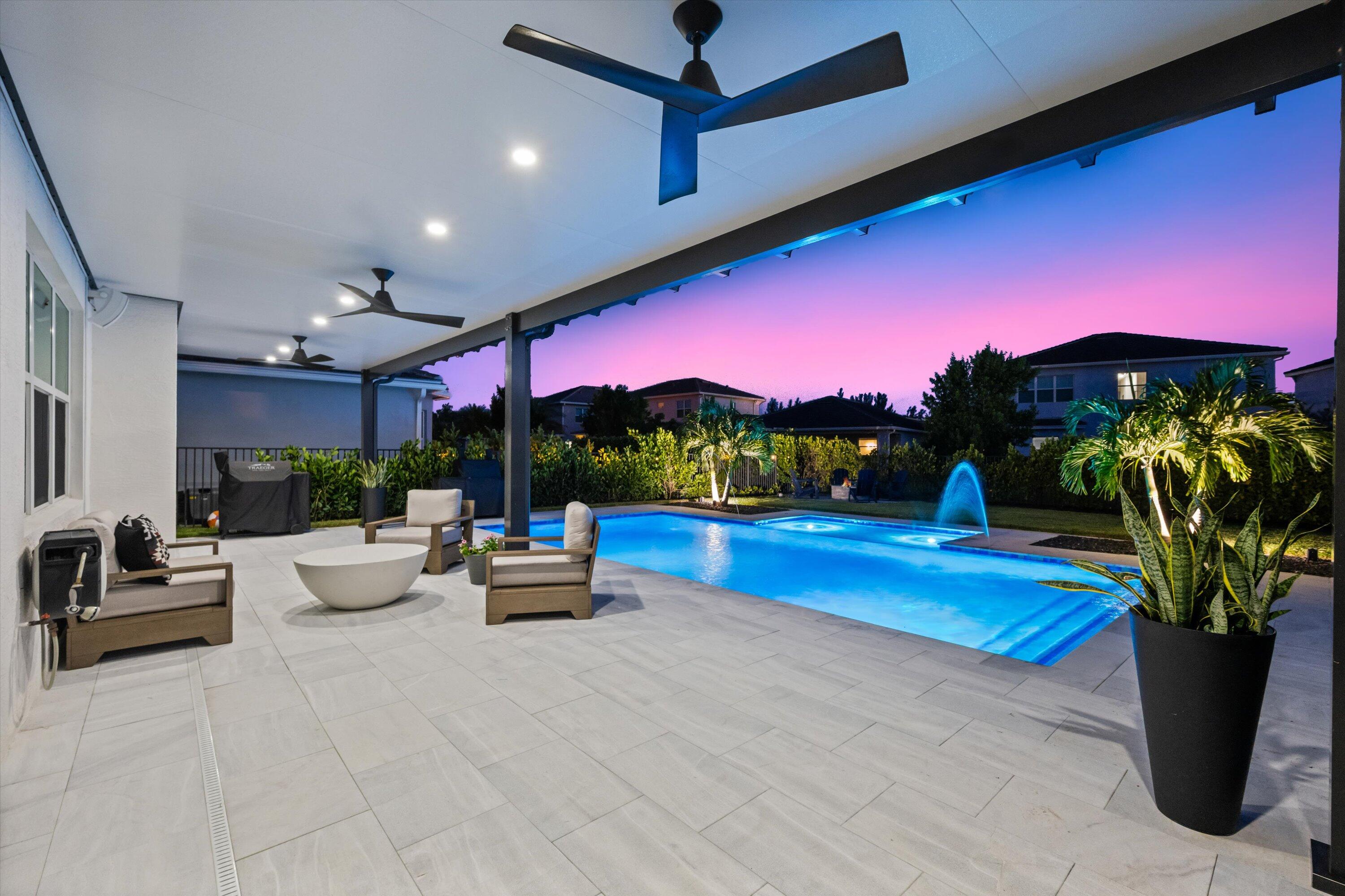 Welcome to this stunning 2-story Poinciana model in the sought-after Groves community, boasting 2,982 sq ft of luxurious living with 4 bedrooms, 3.5 bathrooms, and a versatile loft. This home is a masterpiece of modern design, featuring an electric-heated saltwater pool, full impact windows with tint for energy efficiency, and a 3-car garage with epoxy flooring.