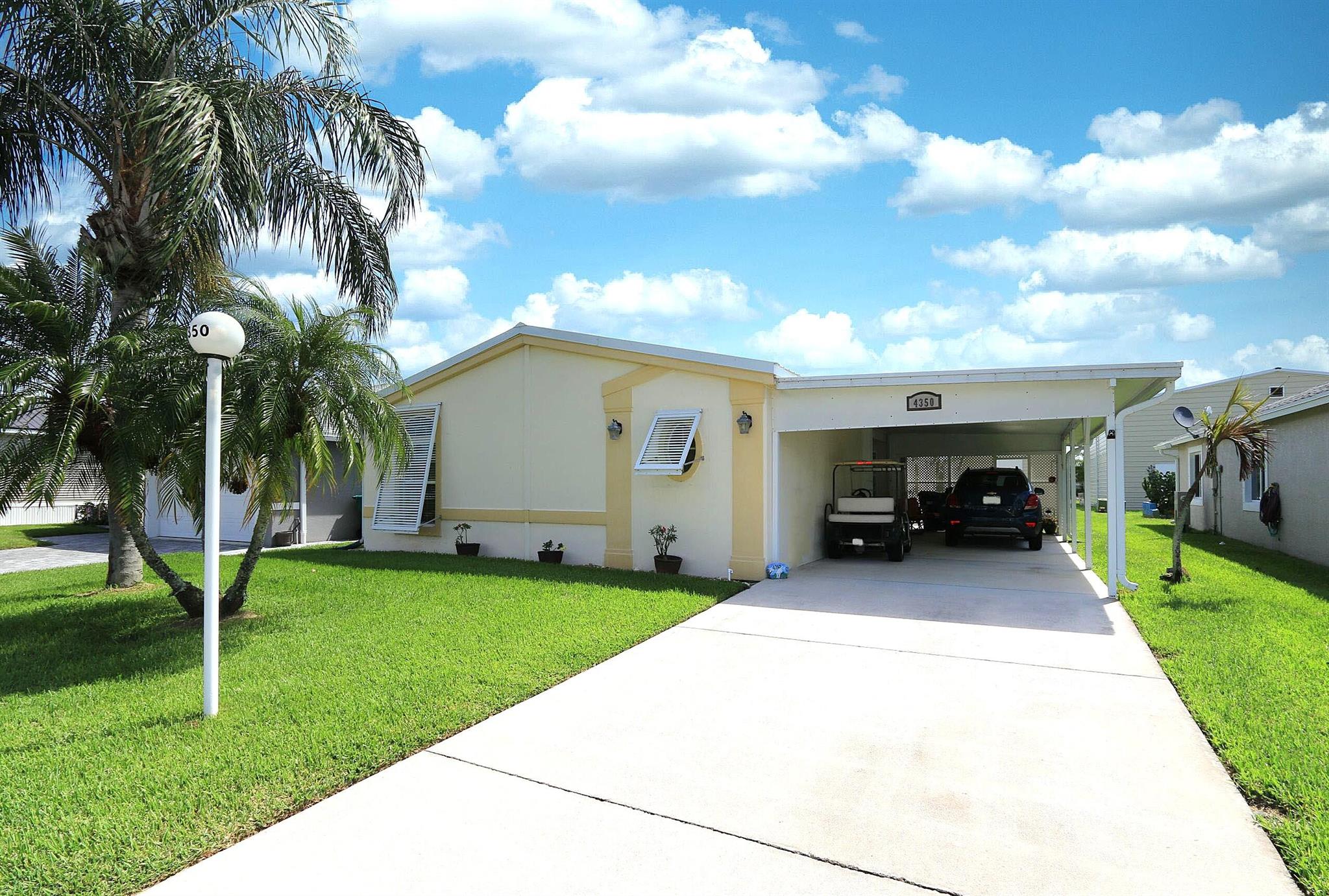 Looking for your Dream home in the Desirable Palm Village Ranch, a 55+ community in Okeechobee! This home is Unique, being a Solid Concrete Modular home, Not the Wood Modular. The Oakbrook by Royal Concrete Concepts states is built to withstand Category 5 Hurricanes and offers contemporary style, Bahama & Accordion Shutters for Peace of Mind. Enjoy 1,873 sq. ft. total / 1,355 sq. ft. living, and offered partially furnished with 2 bedrooms, 2 baths, a huge living room, and open layout. The kitchen boasts white appliances, white cabinetry, & generous storage. Features includes a New Metal Roof 2015, sprinkler system, concrete driveway, carport, & shed. Community perks: clubhouse, pool, fitness center, game room, craft classes, shuffleboard, bingo, and lawn service and Low HOA fee $72 Month