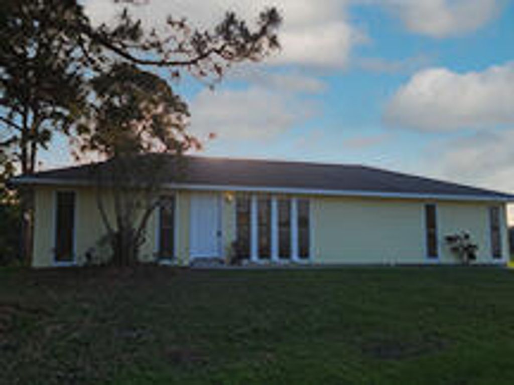 Photo of 1302 SE Manth Lane, Port Saint Lucie, FL 34984 (MLS # R10787257)