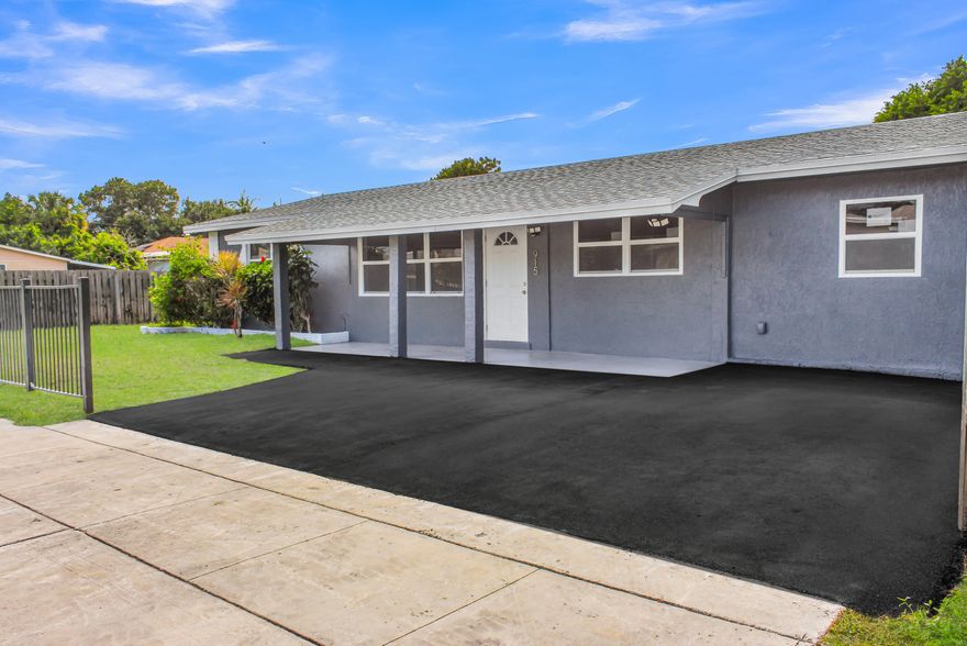 Step into modern living with this freshly remodeled spacious 3-bedroom, 2-bath home featuring an attached 1-bedroom, 1-bath suite— perfect for guests, extended family, or additional flexibility. A corner lot residence, featuring porcelain tile throughout, a newer A/C, impact windows, and a 2022 roof for ultimate peace of mind. The designer kitchen showcases a sleek island perfect for entertaining Enjoy enhanced curb appeal with a brand new driveway, fresh landscaping, and a full irrigation system operating on well system.   Perfectly located near the beach, top-rated schools, shopping, and entertainment—this is one making it a convenient living for a family!