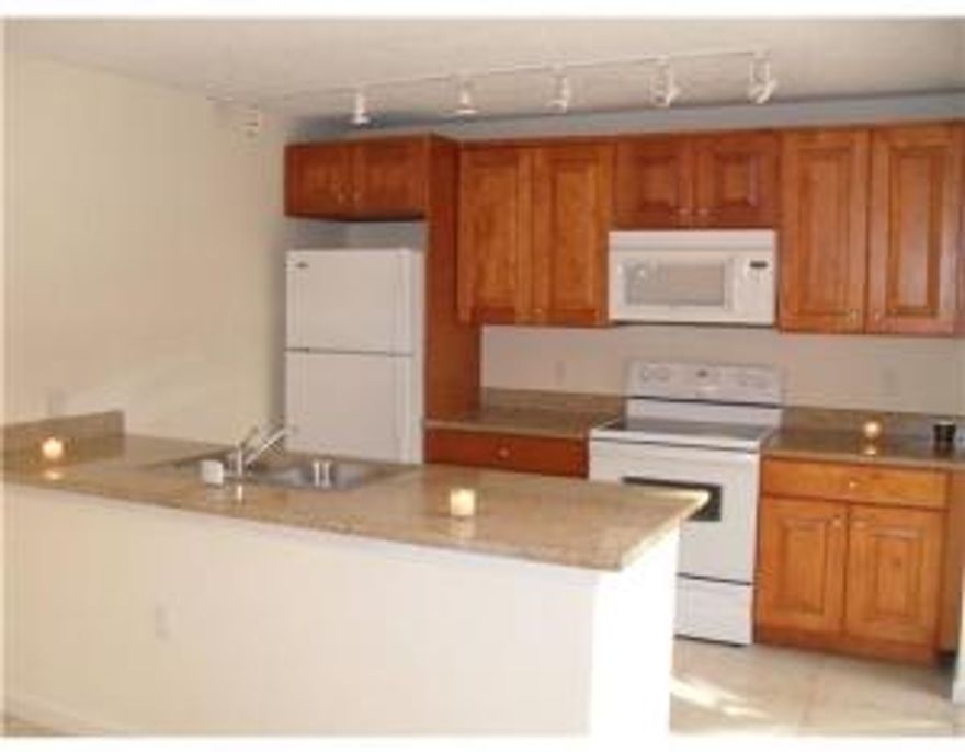 Nice open kitchen w/ granite counter tops and upgraded kitchen cabinets. Washer and dryer in the unit. Tile on the 1st floor and carpet upstairs. Beautiful townhouse with a lake view. Large patio all fenced in. Excellent location! Close to shopping, restaurants, schools, Palm Beach Outlet, CityPlace and airport.