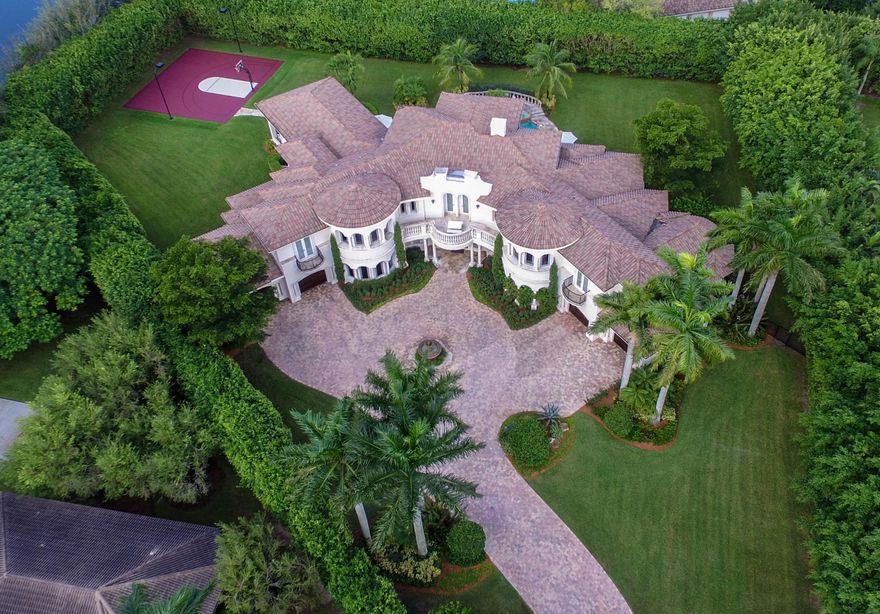 Nestled on 1.25 acres of secluded landscaping this sprawling estate is haven for those who want to enjoy a luxurious lifestyle. In the heart of Boca Raton, Long Lakes Estates sits amidst acres of tree lined streets and distinguished estates. Built in 2005, this magnificent 10,000 square foot property offers six bedrooms, seven full and two half baths, four car garage with motor court. This elegant gem is designed to perfection, styled flawlessly for both indoor and outdoor Florida living while taking advantage of the beautiful scenery that surrounds it.