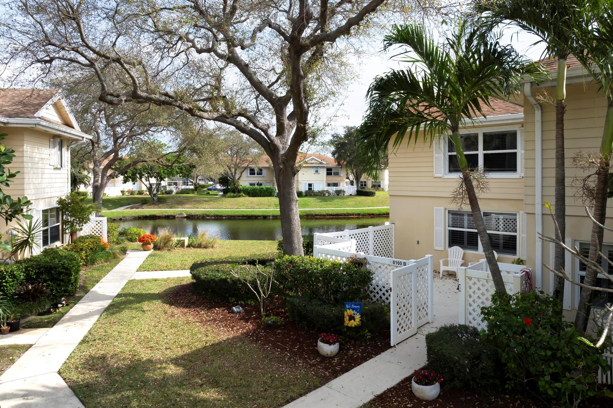 Motivated sellers, ready for all reasonable offers! Price reduced! Welcome to this charming 2-bedroom, 2.5-bath lake view townhome nestled in the gated community of Wellesley at Lake Clarke Shores. Step inside to discover a spacious open-concept floor plan, featuring stylish plantation shutters and durable tile and laminate flooring. The kitchen is equipped with stainless steel appliances, tile countertops, under-stairs storage off the dining area, with a washer and dryer tucked away in the half bath. Upstairs, enjoy engineered flooring, crown molding, and ceiling fans, along with ample storage, including a walk-in closet in the master suite. The master bathroom boasts dual sinks, and the second bedroom's bath has been tastefully remodeled.