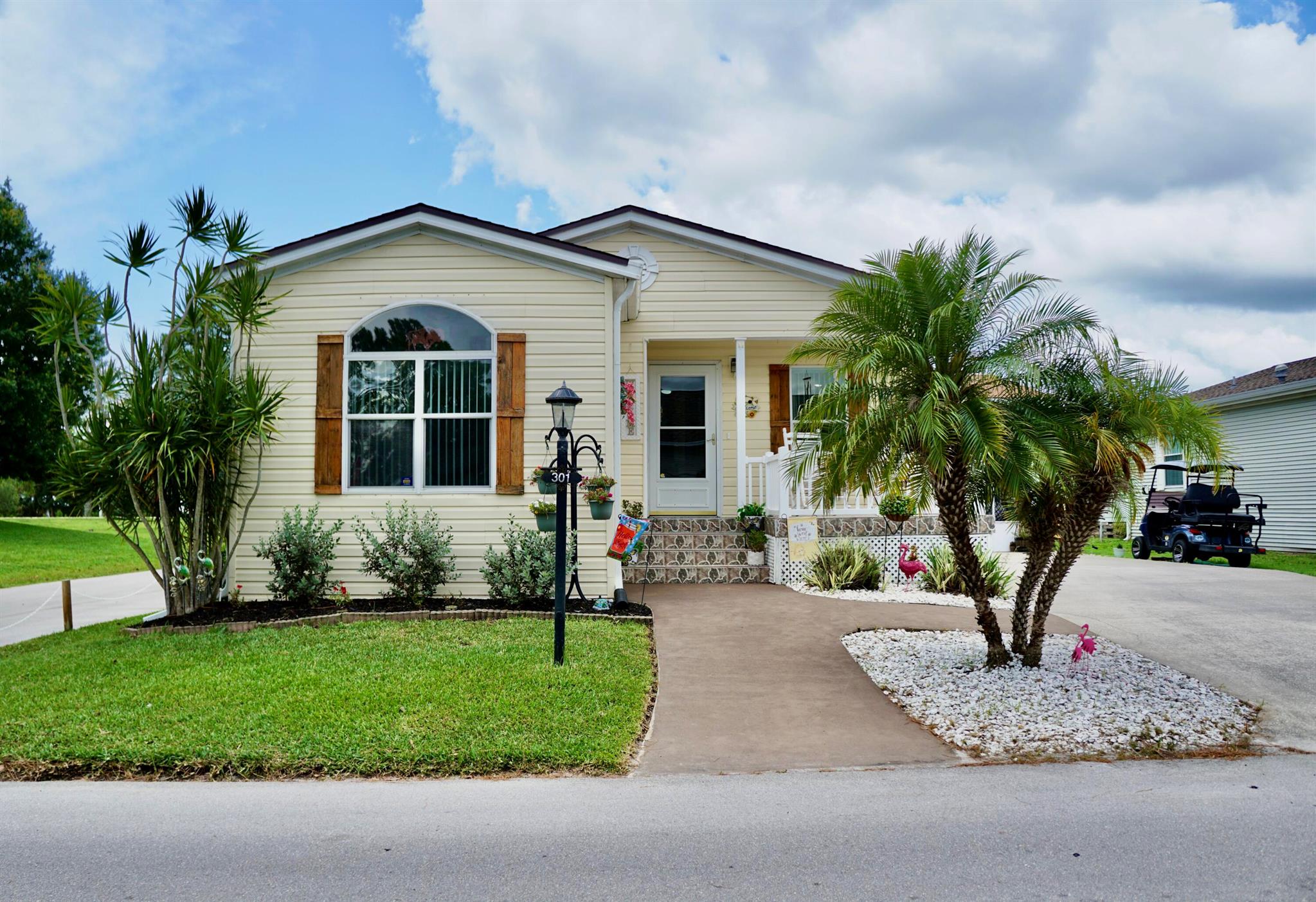 RELAX in this impeccably maintained 2003 Palm Harbor 2 bed/2 bath + den home in a vibrant 55+ community. Kitchen was remodeled in 2024 to create a large open concept, perfect for entertaining. Updates include a NEW ROOF in 2025, NEW AC 2022, NEW hot water heater in 2018. NEW stainless steel appliances in 2024. Den could easily be converted to 3rd bedroom or office. Features inside laundry with washer/dryer. Comes completely furnished (minus personal items). INCLUDES GOLF CART with under 400 miles. 18x14 screened porch for relaxing or entertaining. 14x5 shed for tools & pool floats. The $810 monthly land lease covers lawn care and resort-style amenities: swimming, fitness center, tennis, shuffleboard, and more. Near beaches, restaurants, & shopping. Move in and embrace the lifestyle!