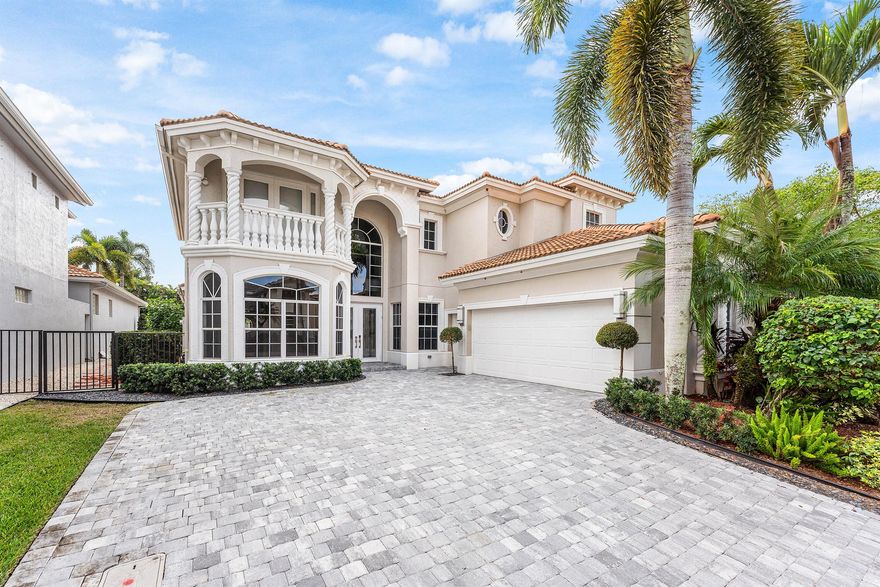 This Mizner Country Club home w/ Southern exposure offers immediate sports membership & home features 4 bedrooms, 5.1 baths, plus an office. Highlights include new quartz countertops in kitchen & baths, new flooring in office & upstairs, a resurfaced pool, newer outdoor kitchen, custom raised deck, &  expanded driveway. A two-story covered entry opens to a spacious foyer, study, & private en-suite guest room. Soaring ceilings & a curved staircase frame the formal living & dining areas. The family room adjoins the covered lanai w/full cabana bath & the generous kitchen. The primary suite has coffered ceilings, two walk-in closets, & a luxurious bath. Upstairs, two en-suite guest rooms connect to a loft overlooking the main living spaces. Mizner Country Club offers resort-style living w/an