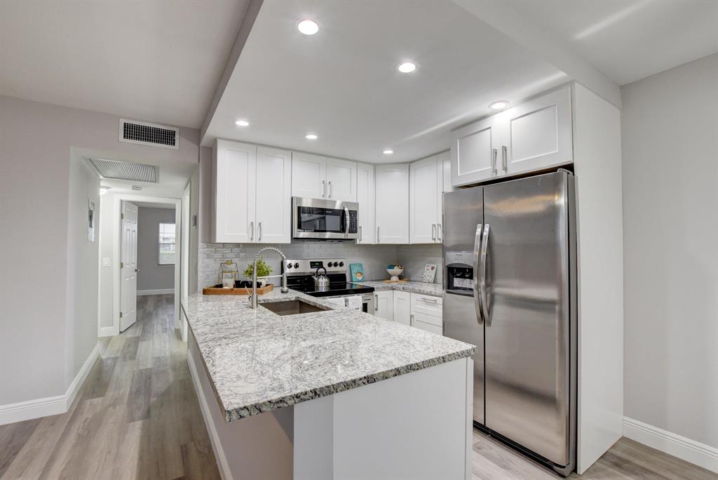 Completely renovated 2/2 ground floor unit in highly desirable Exeter in Century Village. This unit has it all and is ready for a new owner! Brand new open kitchen with white cabinets, subway backsplash, granite countertops, and stainless steel appliances, brand new bathrooms, all new high end flooring throughout, freshly painted, level 5 smooth ceilings, new fans and fixtures, new tankless hot water heater, new electrical panel, and the list goes on! Fabulous water view from both bedrooms and the patio. Schedule a showing today. You will not be disappointed.