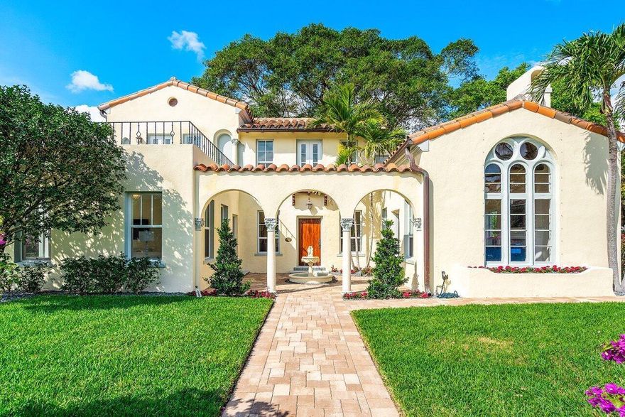 On historic Bankers Row just off Atlantic Ave, this 1925 Mizner-style estate offers timeless elegance and modern luxury. The 3BR/2BA main home features impact windows, a new barrel tile roof, and curated designer finishes. A detached 1BR/1BA guest cottage with private entrance and kitchenette provides space for guests or rental income. Gated and walled for privacy, the lush grounds include a stone courtyard, tranquil fountain, and a majestic century-old banyan. A rare offering in Delray's most coveted historic district.