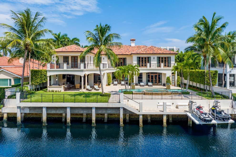 Located in one of the most coveted waterfront sections of Royal Palm Yacht & Country Club, this five-bedroom custom residence built by SRD Building Corp is in pristine condition, providing a like-new feel. This beautiful home is offered fully furnished & turnkey with luxurious furnishings throughout. With over 10,000 total sq ft, the estate features an open floor plan; 4-bay garage; chef's kitchen; club room with theater; dedicated study; integrated smart-home Crestron system, Vantage lighting; 70kw generator; large elevator; spacious primary suite with morning bar, dual baths & closets, impact doors & windows, full of natural light. The resort-style backyard features an expansive covered loggia; pool & spa; summer kitchen; large turf yard, 100' of waterfrontage and dock.