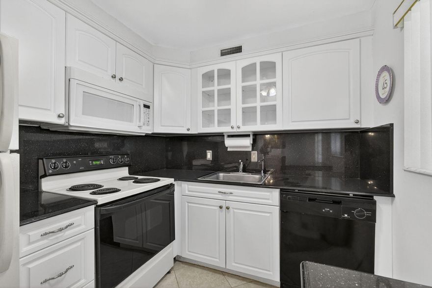 MOVE IN READY 2 BED 1.5 BATHS GROUND FLOOR CORNER PARTIALLY FURNISHED UPDATED WHITE KITCHEN WITH GRANITE COUNTERS VERY CLEAN NO CARPETING EXTRA WINDOWS EXTRA SUNLIGHT CENTRAL AIR CONDITIONING. NO CARPETING  LANAI HAS DOOR TO GO OUT BACK WELL MANAGED ASSOCIATION ROOF WAS REPLACED 2023 AND THEY HAVE AN OPEN PATIO TO SIT OUT AND RELAX ON. FANTASTIC CENTRAL LOCATION CLOSE TO HASTING FITNESS CENTER AND THE CLUBHOUSE. COME AND ENJOY RESORT STYLE LIVING IN CENTURY VILLAGE A GATED COMMUNITY FOR ACTIVE ADULTS 55+ CLUBHOUSE features a theater, indoor pool, card room, community/party room, billiard room ,shuffle board ,tennis , pickleball ,bocce and two outdoor pools. Numerous heated outdoor pools throughout the community. Separate fitness center with gym , outdoor heated pool and a resistance pool. Two guarded gates and 24 hour roving security patrol. GREAT LOCATION: close to shops, restaurants, PBI airport and beaches.