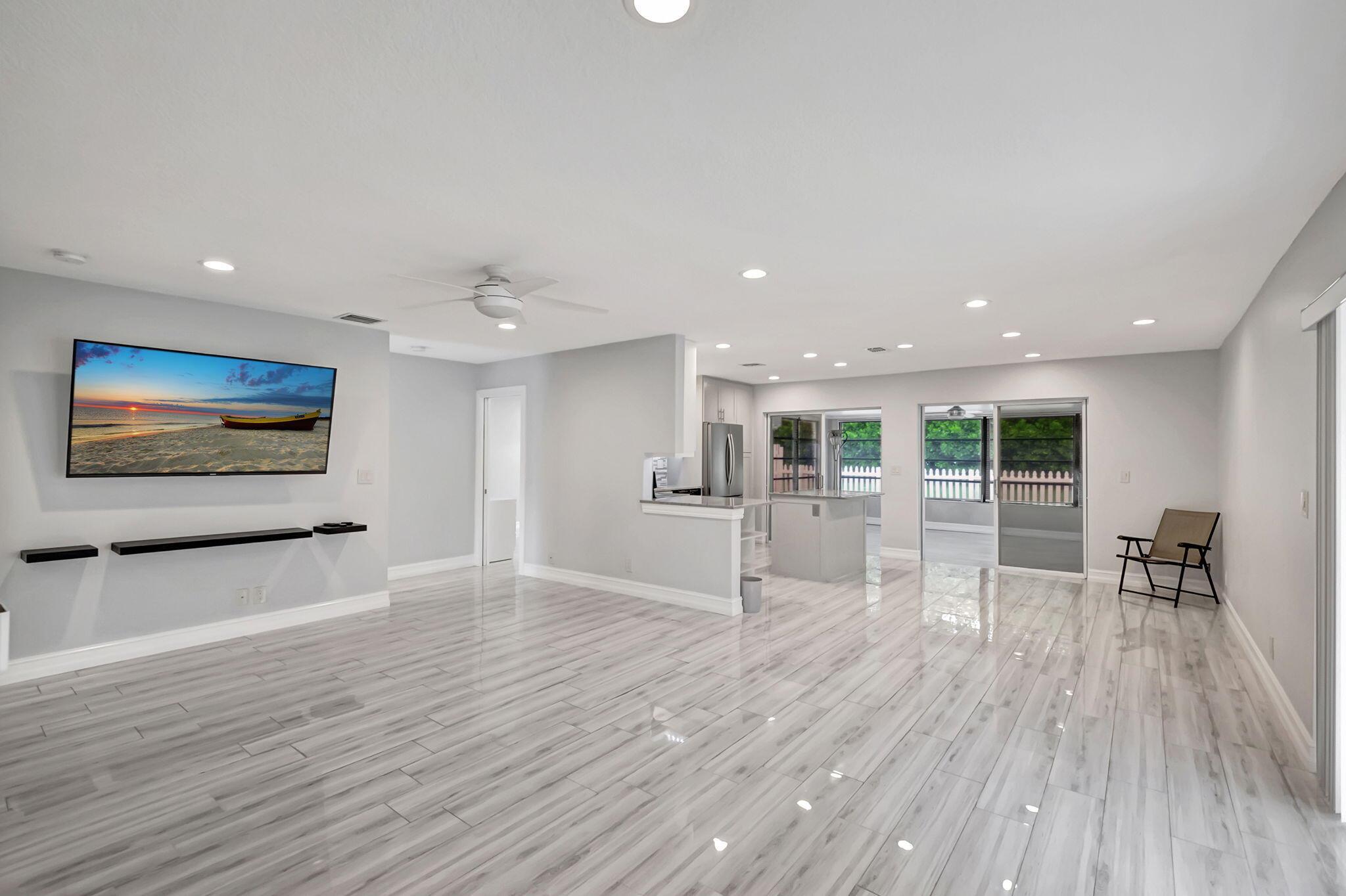 Rent where luxury meets cozy. Beautifully remodeled 2BR, 2BA home, 1472 Sq. ft, w/ A/C'd FL room & 1 c gar. Contractor's home; no expense was spared in the quality upgrades & tasteful appointments thru-out. Beautiful kitchen offers crisp white wood cabinets, gorgeous granite counters, stainless appliances. Master suite features large, walk-in closet with organizer unit, and a dazzling ensuite bath. An equally lovely guest bath can be accessed privately from 2nd BR & from the hall. Gleaming tile floors & high-hat lighting thru-out, new windows. Fenced backyard for enjoying sunrises & breezes from the east. HOPA Adult 55+, gated & lovely, w/pickle ball-tennis, billiards, htd. pool & lakefront walking promenades & more. Walk to stores & restaurants, convenient to beach, airports, highways.