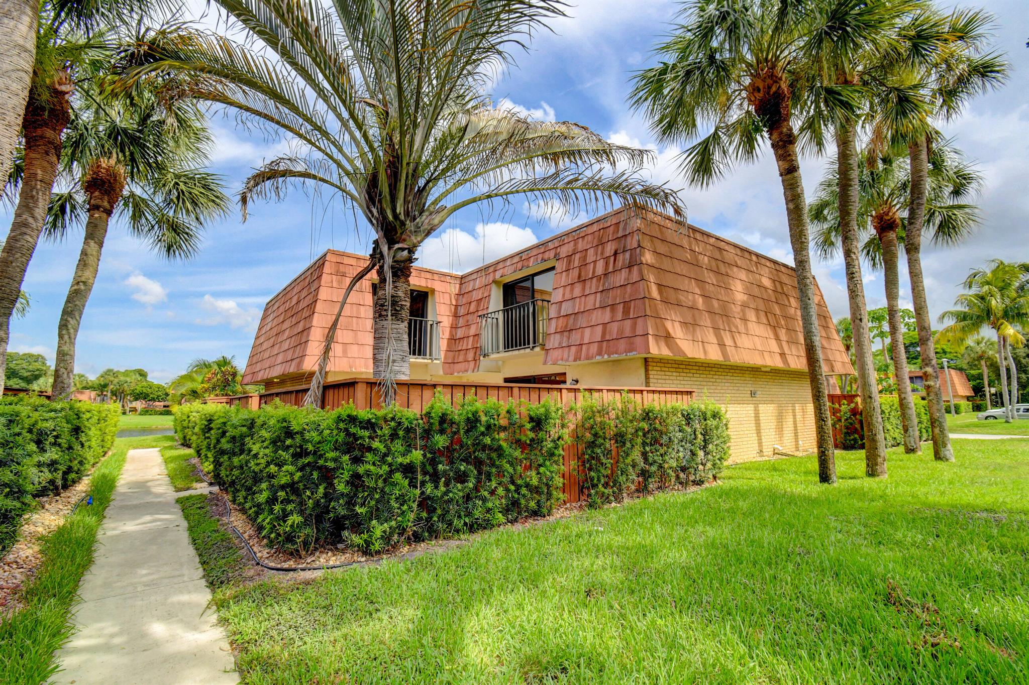 Beautiful, well maintained 2 Bedroom, 2.5 bathroom townhome in the desirable community of Sandalwood of Boynton Beach. Spacious floor plan. Open living room. Tile throughout the first floor. Large private fenced in courtyard. Plenty of storage. Balconies on both the master and guest bedrooms. Amenities including an Olympic size pool, 4 tennis courts, 2 racquetball courts, and a full size basketball court. Easy access to almost every restaurant and store you can think of. Minutes from the main highways. This property won't last long. Call to schedule a showing today!