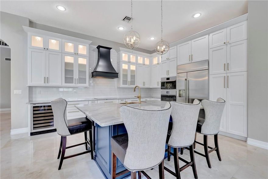 Enjoy this Gorgeous Waterfront Estate with 6 beds, 5 baths, plus office and oversized bonus space on a quiet cul-de-sac nestled in Heron Bay Oldbrooke. BRAND NEW Gourmet GE Advantium kitchen w/ stainless steel appliances, double oven, wine fridge, farm sink, and 7x4 ft island quartzite island.  Marble floors line the main living areas with grand 20 ft ceilings, built-in speakers, upgraded ceiling fans & chandeliers, and window treatments. Enjoy 2 walk-in closets and a cozy sitting area in the spacious master suite. The private fenced backyard features a heated SALTWATER Pool & Spa, lush tropical landscaping, motorized retractable patio screen, and 100+ ft of waterfront frontage. Freshly painted, accordion shutters, central vacuum, and a transferrable home warranty. Roof=2018, 3-A/Cs=2015