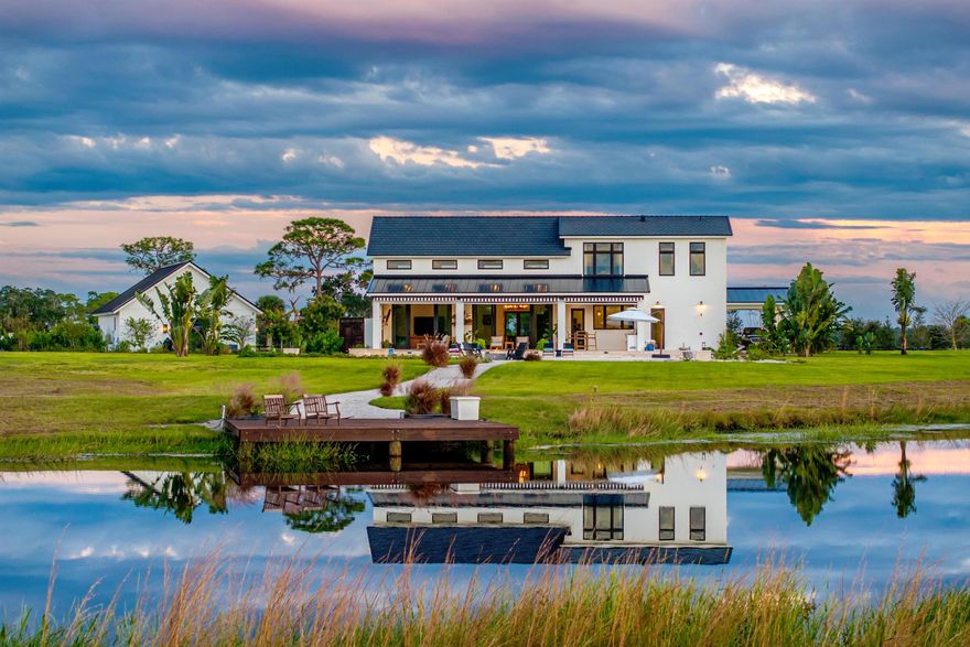 MARTIN MANOR is a singular jewel within Martin County Ranches--a distinguished estate of enduring elegance, set upon twenty pristine acres along the storied Martin Grade Scenic Highway. This remarkable Florida residence evokes the noble character of a Scottish manor, the refined allure of an English estate, and the warmth of New England tradition. Two fireplaces lend intimacy, while retractable screens and UV awnings extend outdoor living through every season. The great room soars with lofty ceilings, French doors open to wrap-around porches, and the primary suite offers a private retreat with outdoor access. See Brokers Remarks.