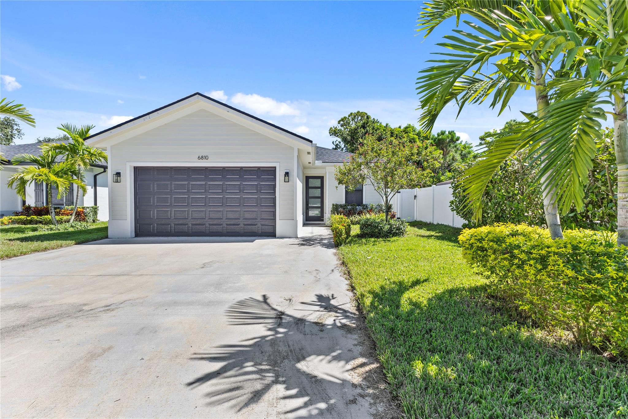 Welcome to this stunning 4-bedroom, 2-bath single-family home built in 2022, perfectly situated in the desirable Jupiter area. This modern residence offers an open, light-filled floor plan, sleek wood-style ceramic tile flooring, and hurricane impact windows and doors. The kitchen is equipped with stainless steel appliances, with 42" cabinets and quartz countertops. Tankless water heater ensures efficiency and convenience. Enjoy privacy in the fully fenced backyard—perfect for relaxing or entertaining. With its contemporary finishes and prime location, this home is move-in ready and waiting for you!