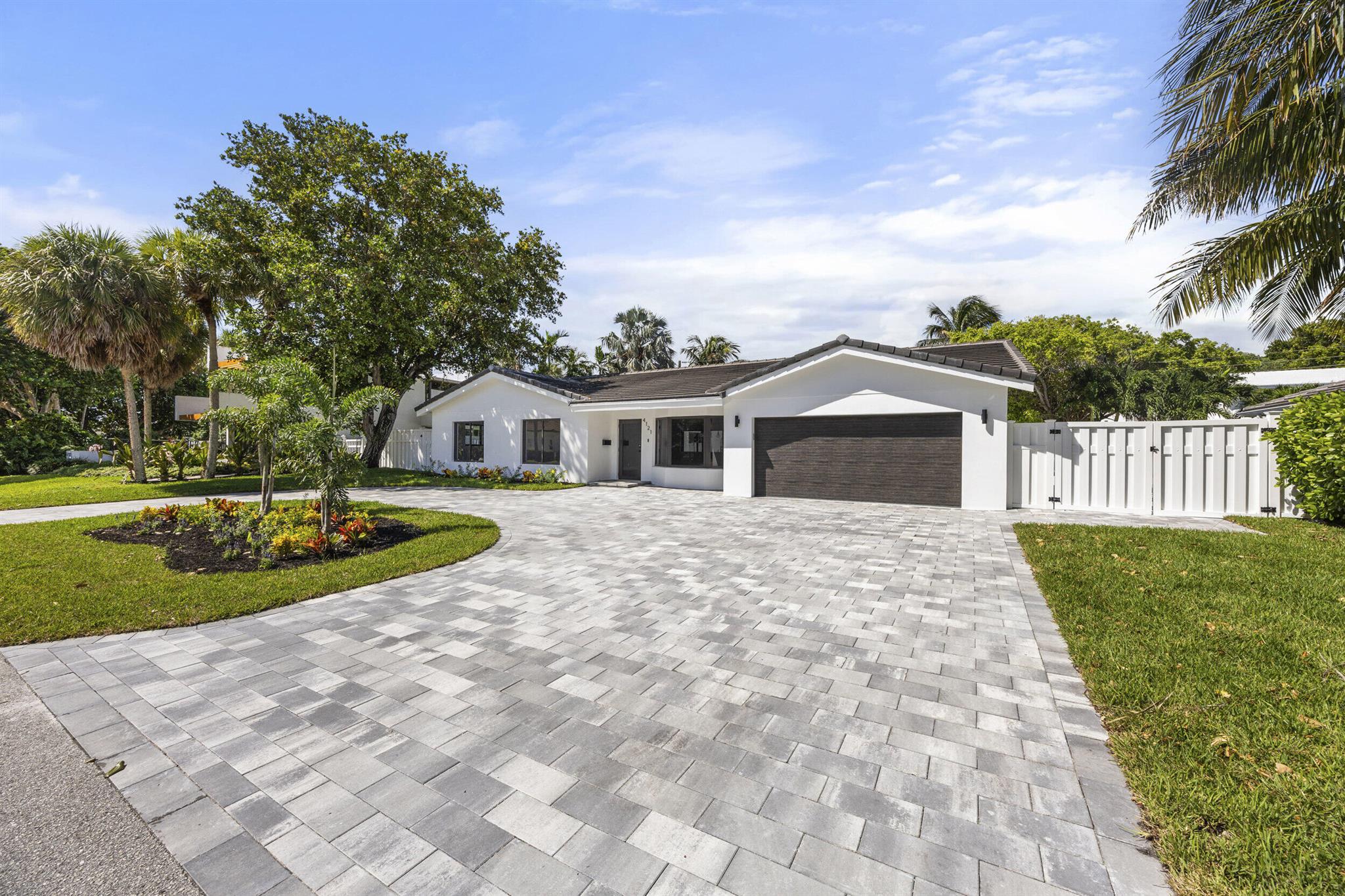 Welcome to your dream home! This beautifully updated modern house offers style, comfort, and peace of mind. Inside, a cozy, open-concept living space is filled with natural light from brand-new impact windows and doors. The state-of-the-art kitchen features a stunning waterfall island, ideal for casual meals or gatherings. Outside, enjoy a private oasis with a sparkling saltwater pool. The home also boasts updated bathrooms, plumbing, electrical (including underground power lines), and roof. Move right in and make this inviting, modern space your own! The Lighthouse Point Yacht Club is currently undergoing a multimillion-dollar renovation and is less than a mile away. Club membership is constantly growing and it promises to be the most sought after club on the east coast.