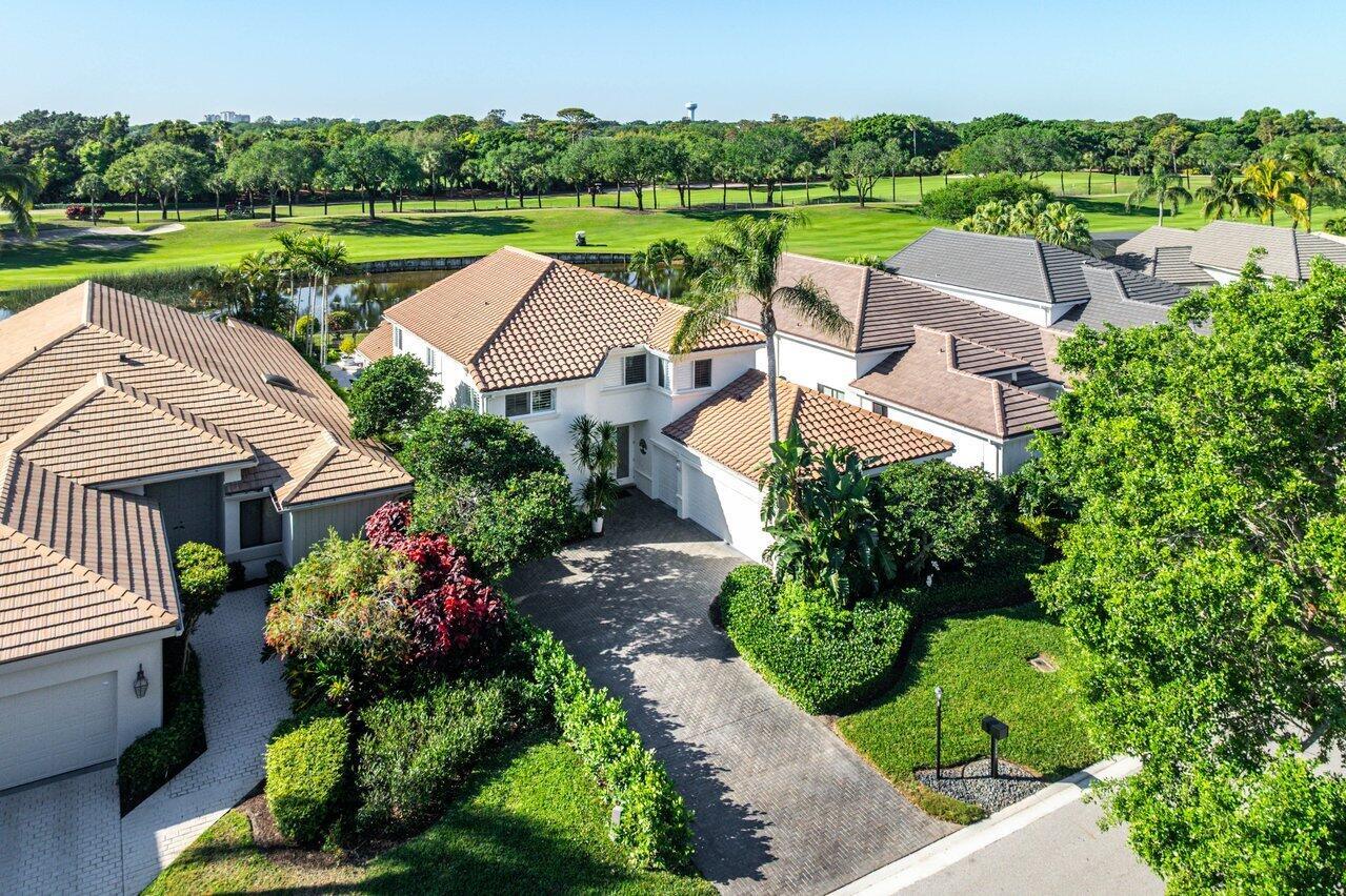 A short stroll away from a magnificent, new clubhouse, across the road from a beautifully landscaped driving range, walking distance to all dining and member amenities in the heart of the perfection that is Frenchman's Creek Country Club, lies a glittering jewel of a home. With gorgeous Southern exposure fairway and water views in back and only lush gardens and trees in sight, your privacy is guaranteed - enjoy peace and tranquility from the comfort of your covered and screened lanai and resort-like travertine pool and spa deck.Inside find a warm, welcoming interior with unique touches like imported Brazilian wood flooring; spacious study with rich maple paneling, desks and cabinetry; custom designed staircase, soaring ceiling with wall of windows highlight sweeping garden and golf