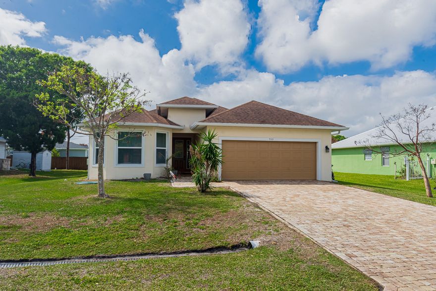 Step into this custom-built 4BR/3BA/2GAR home where  11'-12' ceilings and a grand foyer create an impressive first impression. Designed with a desirable split floor plan, the home features a bright open great room, 8' interior doors, and sleek 24" polished tile throughout. The stylish kitchen showcases white shaker soft-close cabinetry, granite & quartz countertops, and stainless steel appliances. The spacious primary suite offers dual sinks, a Roman tub, and walk-in shower, plus generous closet space. Enjoy indoor-outdoor living on the covered, screened lanai. Complete with impact windows & doors, 2-car garage, and laundry room with washer, dryer & laundry sink. Ideally located near shopping, Tradition Hospital, and major highways—schedule your showing today!