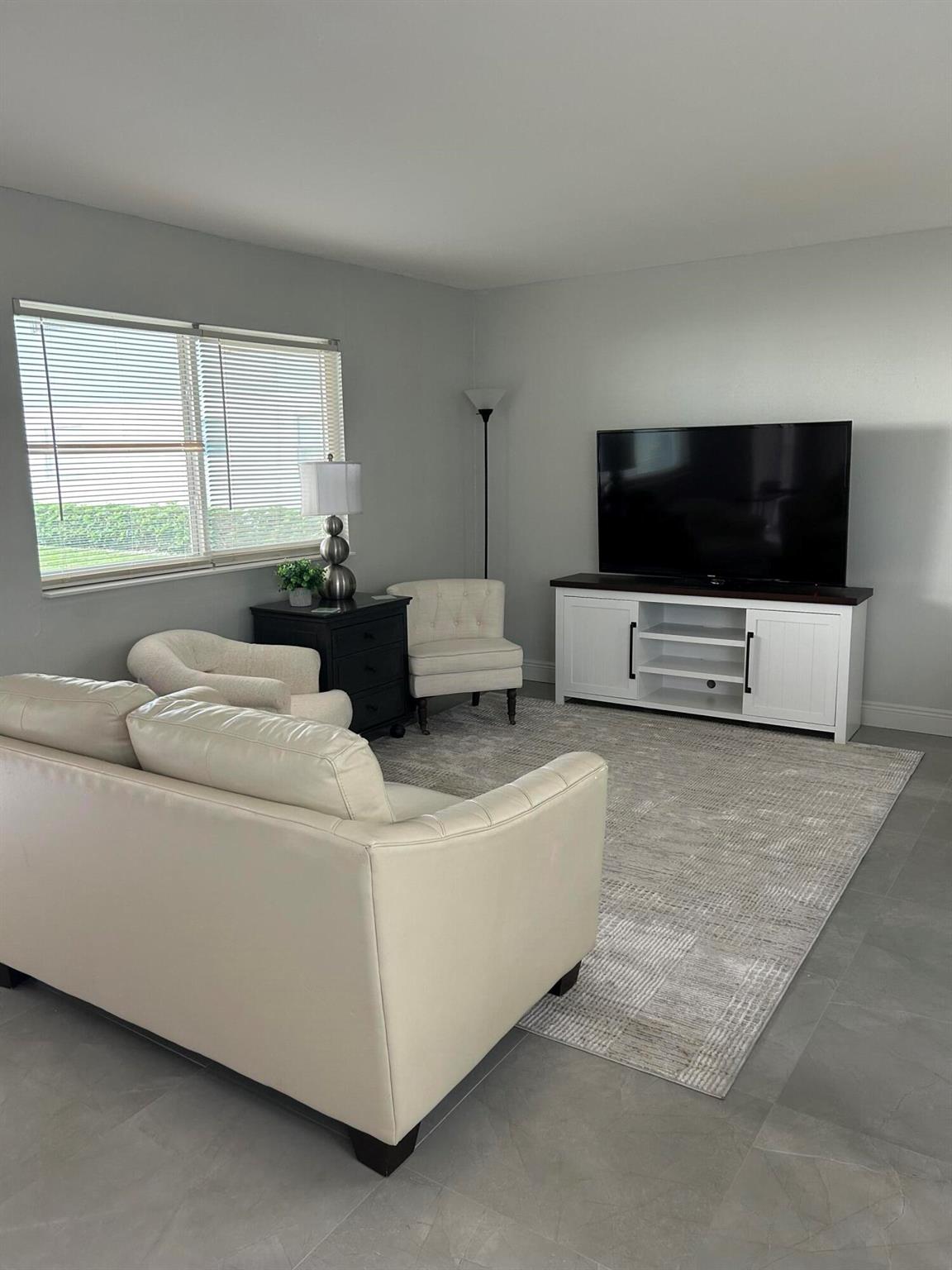 Beautifully remodeled furnished condo with brand new cabinets and stunning granite countertops, complemented by porcelain tile flooring throughout the home. Enjoy the benefit of appliances that are less than 5 years old, along with your own in unit washer and dryer for added ease. AC is 3 months old.The closed porch, transforms into a fantastic Florida room ideal for relaxation. while a reserved parking space right in front of the property, provides convenience. Situated in a beautifully kept neighborhood, this home offers access to a fantastic clubhouse, a golf course, multiple pools, and a range of amenities. Just bring your personal belongings. Can be leased yearly or seasonally!
