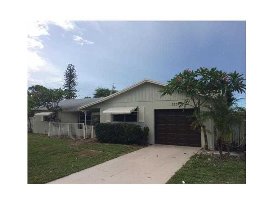 This centrally located home has an oversized private lot with mature trees and is situated on quiet street in family oriented neighborhood. This spacious house has a split Floor plan with master suite and separate Living and Family rooms. It has been fres hly painted inside and out has new carpeting in the bedrooms. The yard is fenced, it has a large screened patio, a greenhouse and a whirlpool spa. The property is located just minutes from I95 and the Boynton Beach mall. Turnkey and ready to move in.