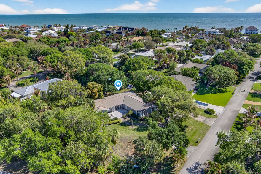 Located East of A1A with beach access. Make this your home. Very close proximity to St Edwards School & across the street from the Moorings golf course. 4BR, 3BA Concrete Block construction with newer 2021 roof located on .39 acre lot. So much potential. Large circular front driveway & side entry garage with more parking! Very low optional HOA fee helps maintain beach access. Sizes are approximate and subject to change.