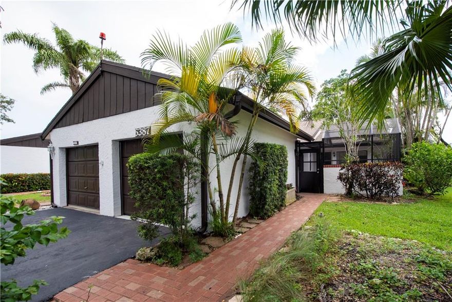 Move right in to this perfect open concept Villa in a great Golf Course community. This 2 bedroom 2 bathroom corner unit is the most premium lot with water with golf coarse views. You will love this home's contemporary style, gray porcelain tile though out, white wood shaker kitchen cabinets and beautiful granite counter tops.  New garage motor installed that comes with remote for easy covered parking year round. Bedrooms are spit , both very spacious with walk in closets. Enjoy your water views from the screened in outdoor patio or just cross the street and enjoy the pool and community club house. This 2 bedroom 2 bathroom corner unit. You will love this home's contemporary style, gray porcelain tile though out, white wood shaker kitchen cabinets and beautiful granite counter tops.