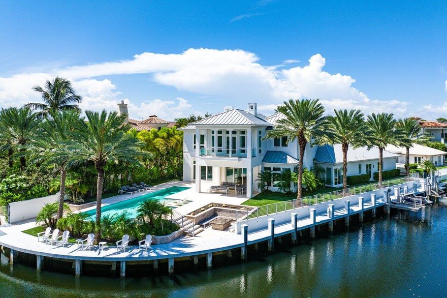 Experience exceptional waterfront living at 551 NE Waterway, an extraordinary custom residence. Set on a unique point lot within a cul-de-sac in Golden Harbour, one of Boca Raton's most prestigious waterfront neighborhoods, this stunning home offers unparalleled entertaining spaces both indoor and out. With 210 feet of dockage and direct Intracoastal access this spectacular property is a boater's paradise and comes with boat and jet ski lifts. Enjoy resort style living with heated pool, spa, fire pit, turf yard, lanai with retractable screens and a full summer kitchen.  This luxurious residence on a third of an acre and spans an impressive 5,683 of interior square feet, offering an elegant blend of style, comfort and captivating water views throughout all of the main living spaces. This exquisite home boasts 4 generously sized ensuite bedrooms, home office, eat in chef's kitchen, butler's pantry, bar, dining room, living room, family room, powder room, two laundry rooms,an elevator and wood flooring throughout.  The sprawling owner's suite, with expansive windows overlooking the water has 2 walk in closets, spa like bathroom, breakfast bar, and a private balcony making it the perfect owner's retreat. The property is equipped with state-of-the-art Control 4 system, allowing you to easily access lighting, climate, security & entertainment equipment. There is also a full house generator and 3 car garage.  You can enjoy the vibrant downtown areas of Boca Raton & Mizner Park, as well as the pristine beaches for which Boca Raton is known for. This coastal modern waterfront property offers exclusivity & convenience, making it an ideal choice for those seeking a luxurious & memorable experience in South Florida.
