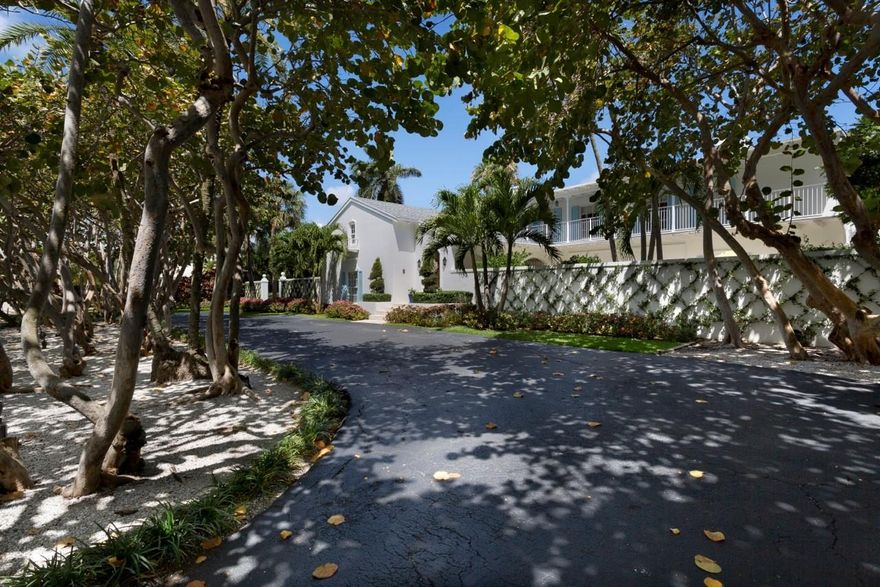 A shady tree-canopied drive to a large, walled garden courtyard with fountain creates a captivating arrival to this recently renovated Bermuda-inspired estate which fronts 150+/- feet on a wide, deep waterway and sits across from the Gulf Stream Golf Club.  Beautifully reimagined, this classic residence opens to outdoor spaces on both sides of each level, taking advantage of the substantial estate grounds embraced in lush greenery.  By manicured lawns on the water side, the outdoor living/dining areas of the long lanai overlook the inviting pool terrace served by a summer kitchen pavilion. The information herein is deemed reliable and subject to errors, omissions or changes without notice.