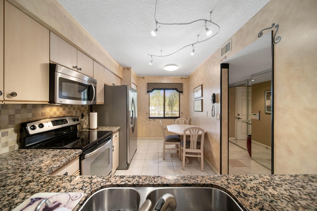 Photo of 6037 POINTE REGAL Circle #307, Delray Beach, FL 33484 (MLS # B26077207)
