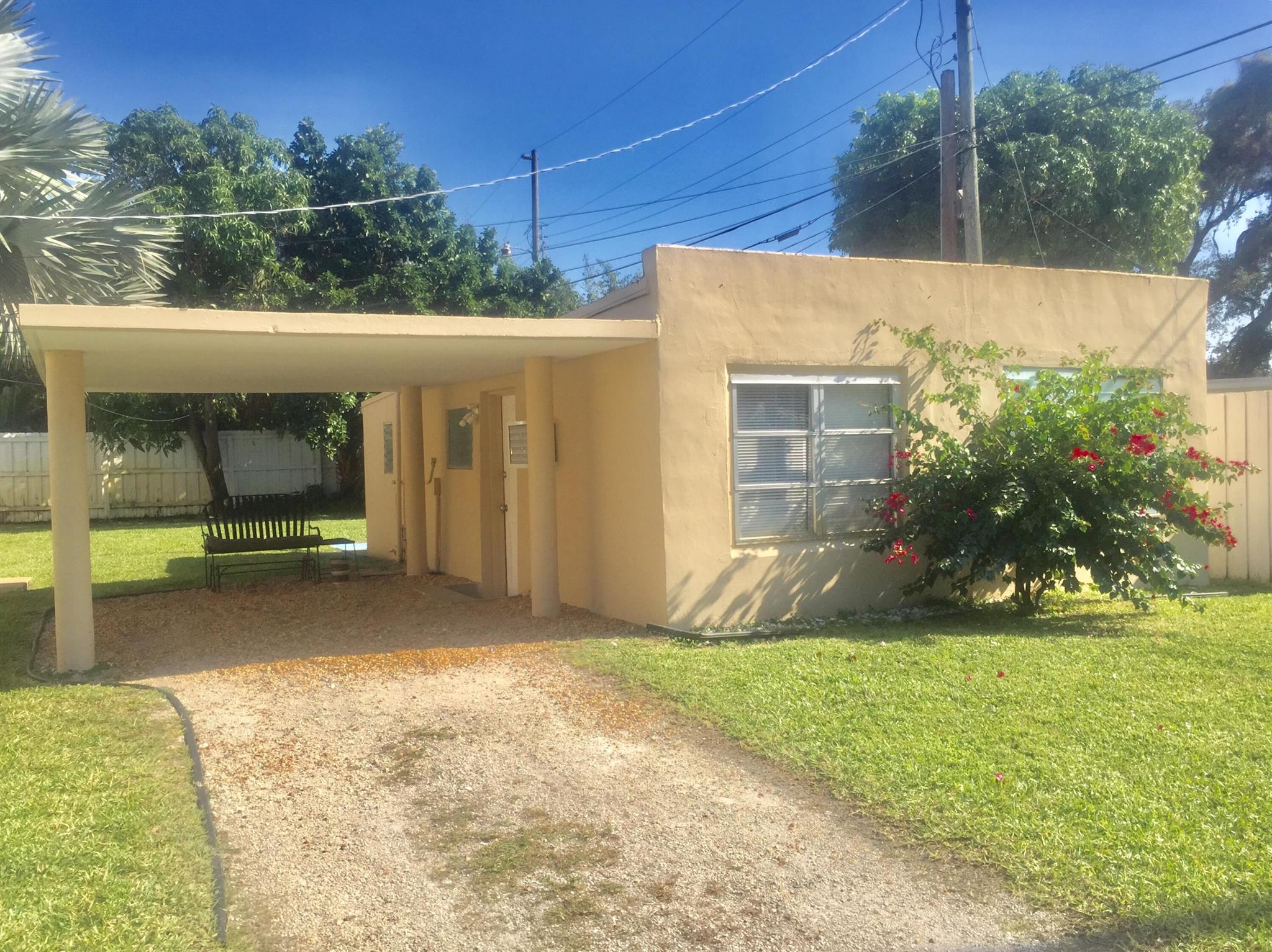 ELECTRIC, WATER INCLUDED! You will love this detached guest cottage in a residential area on a spacious lot just a short distance to the Intracoastal Waterway, Kelsey Park, and Lake Park Harbor Marina. To the west on Park Ave, there is the Lake Park Library and Post Office, and the iconic Brewhouse Gallery and Kelsey Theatre. This private home has tile floors, covered carport parking with its own private driveway on 2nd St. Access to shared FREE laundry area is included! Landlord maintains beautiful large yard. This property is pet friendly for approved animal under 25lbs. Great cottage for 1 person. 650 min credit. ***Available 9/1/25***