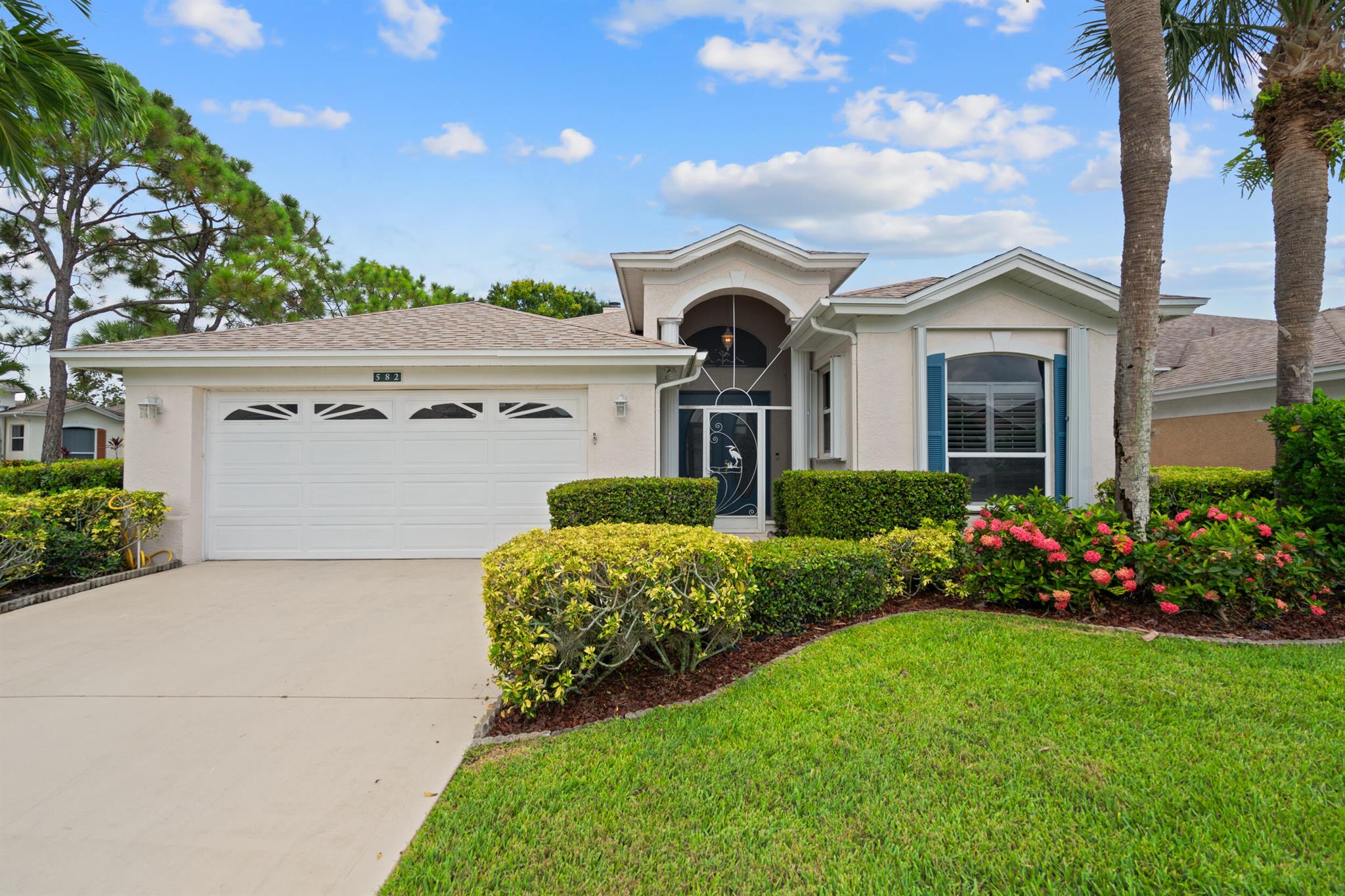 Spacious 2BR + Den, 2BA CBS corner lot home w/2-car garage in the gated 55+ community of Kings Isle (Isle of Capri). Features include volume ceilings, split floorplan, eat-in kitchen w/breakfast bar & pantry, vinyl/tile floors, fireplace, and plantation shutters. Primary suite offers walk-in closet, roman tub, dual sinks. Enjoy a screened patio with shaded back yard view. Full hurricane protection, newer A/C & water heater. Resort-style amenities incl. clubhouse, pool, fitness center, tennis, billiards, and more. HOA covers lawn care, cable, and security. Close to shopping, medical facilities, dining & I-95.