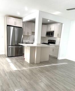 STOP LOOKING- This is the unit for you. Everything new: High quality impact windows and doors, central AC, dishwasher, quartz counter tops, new appliances, open concept kitchen, lights galore, two closets, etc. Beautiful garden view. All done under County permits.