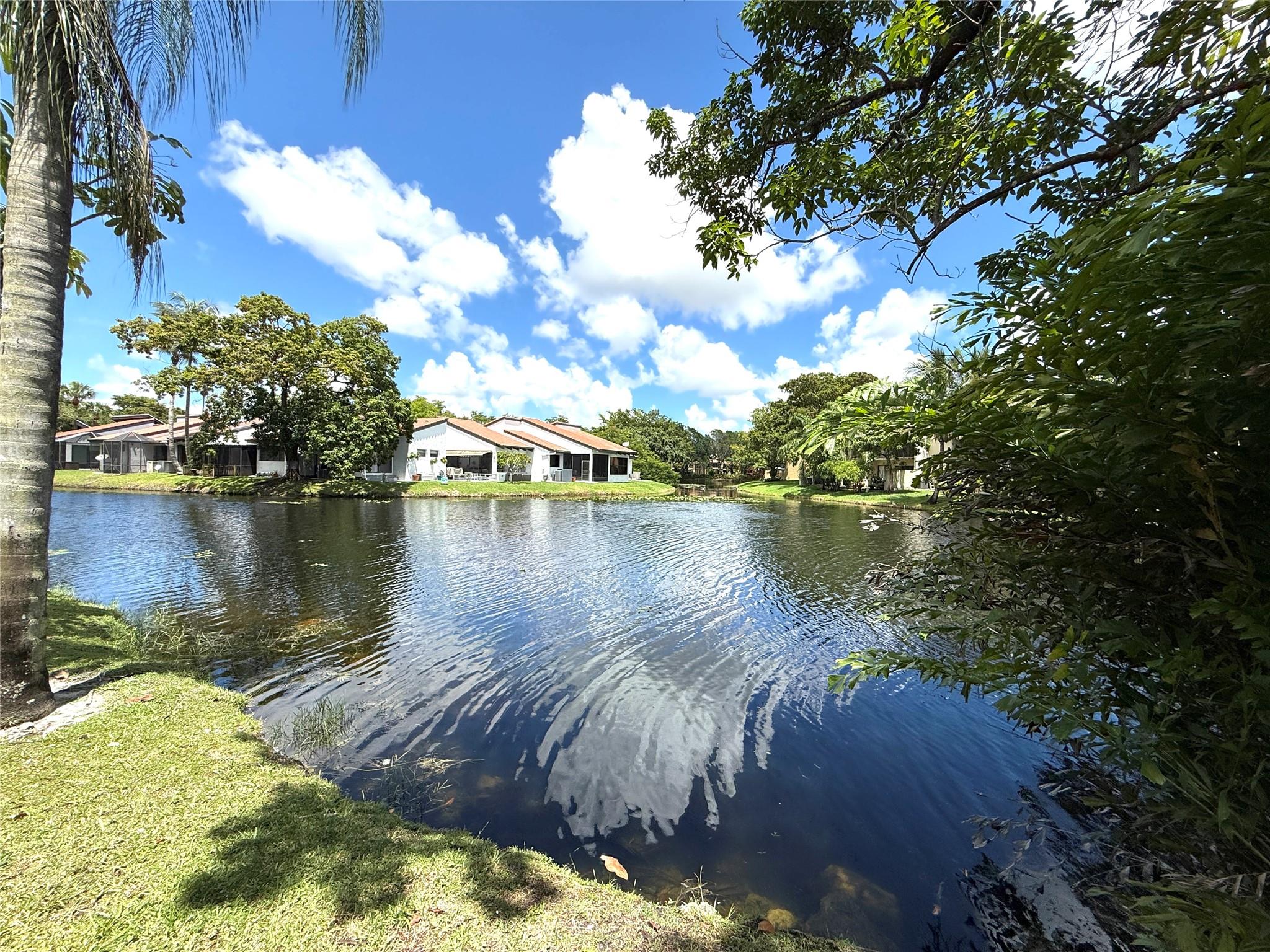 Rarely available, 3 bed/2 bath corner villa on a beautiful lakefront lot in "Cocoranda". Tastefully remodeled single-story home w/vaulted ceilings & porcelain floors throughout. Imagine being greeted by this peaceful lakeview every day! Nothing compares to the tranquil vibe of "The Lake Room"! New W/D & water heater, 2 ZONE A/C. Updated kitchen w/36-inch wood cabinets,pull-out shelves, granite countertops, & newer SS appliances. IMPACT windows & sliding doors, accordion-shuttered front door. Oversized Primary Suite, renovated bathrooms w/skylight. Screened patio overlooking the best view in the neighborhood! Walking distance to the community pool & Jacranda Country Club & Golf Course. Close to shopping, schools, houses of worship, & I-595. Make this property YOUR "Home Sweet Home" today!