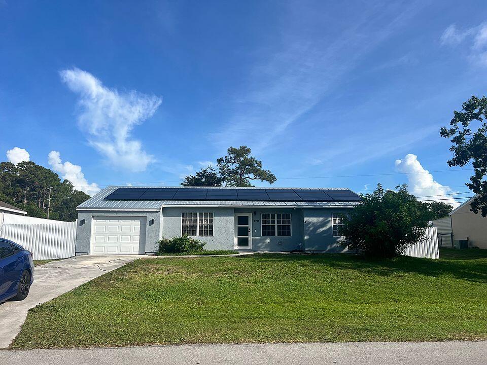 Lease this updated 3 bed, 2 bath home, with Bonus Room featuring new flooring, remodeled kitchen & baths with stainless appliances, hurricane impact doors, Fully privacy fenced yard with a storage shed. Washer & dryer included. Rent covers electricity and water for added value. Conveniently located east of US-1, close to shopping, dining, beaches, and all Port St. Lucie has to offer. No HOA! Pets welcome! Professional photos coming soon. Rent Spree App: https://apply.link/PUll388