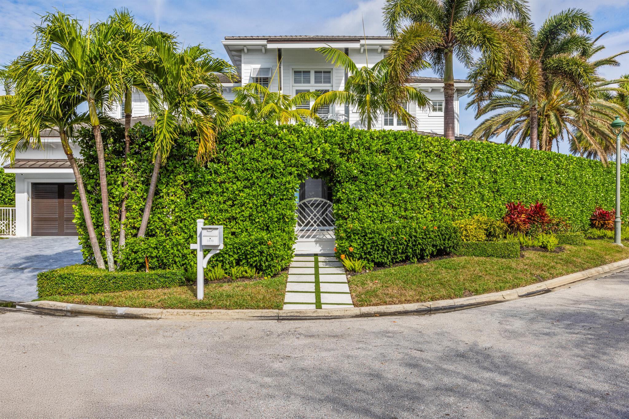 Welcome to 1030 Pine Point, a stunning West Indies-inspired waterfront estate with breathtaking water views offering timeless elegance and modern sophistication. Built in 2017, this exceptional home boasts 150 feet of direct Intracoastal frontage with a 125-foot dock featuring dual boat lifts, making it a boater's dream. Perfectly situated just minutes from the inlet and the pristine beaches of Singer Island, this property offers a lifestyle of unmatched coastal luxury. Spanning nearly 6,500 total square feet, the residence features 5 bedrooms, 6.5 bathrooms, and exquisite craftsmanship throughout. Highlights include European oak wide-plank flooring, a striking Calacatta Maple kitchen island, and a chef's kitchen equipped with top-tier Thermador appliances.