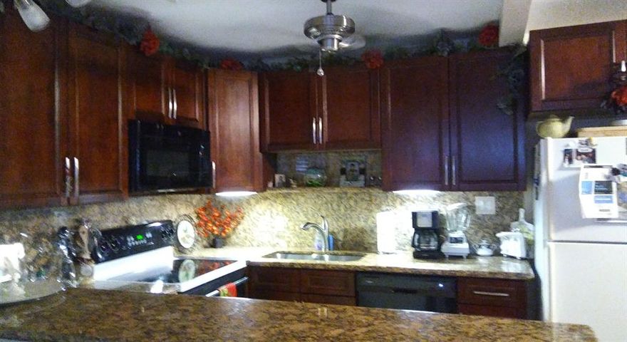 PRICE REDUCED! Move-in condition, 2nd floor, 1 bdrm, 1.5 ba unit. New paint throughout. Totally renovated-granite countertops, new cabinets, open floor plan. New dishwasher, garbage disposal. New A/C. Both baths updated. Flooring is 4 year old porcelain tile/wood laminate. Impact windows w/Plantation shutters. Decorative ceiling fans. This pristine condo includes most furnishings. Negotiable. Located on a quiet street, walking distance to pool and gym. Private balcony w pleasant view! Condo can be easily converted to Central A/C. 55+ Active, 24/7 Manned gate w/patrol Security. Community includes 14 pools, gym, sauna, billiards, dancing, events & Entertainment at the Clubhouse. Courtesy bus service. Walgreens on site. Safe/easy living!!