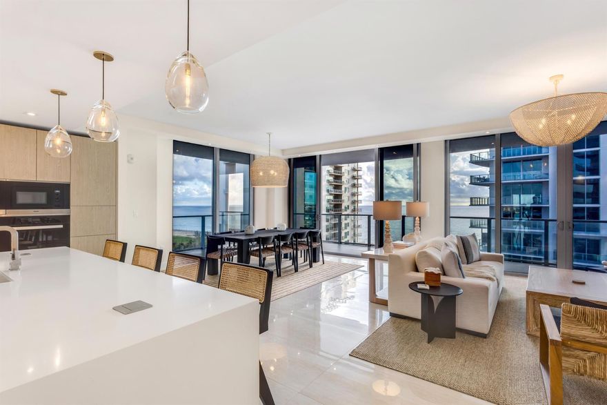 Luxury corner residence wrapped by balconies at Amrit Ocean Resort & Residences offers Atlantic and Intracoastal views with world-class wellness and resort amenities. This elegant condominium invites entertaining with a great room comprising living and dining areas alongside a wet bar, while the kitchen blends form with function. Enjoy sunrises over the Intracoastal from the serene primary suite!